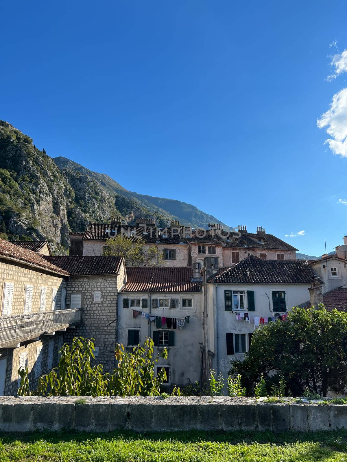 Ancient stone houses with tiled roofs and linen drying on clotheslines. High quality photo