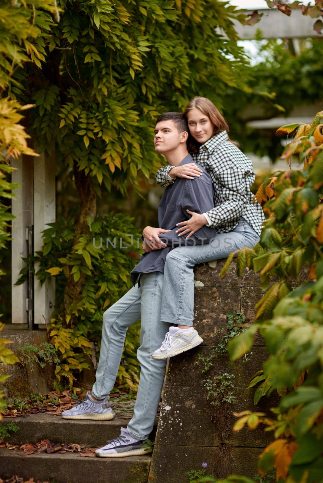 Love's Moments: A Young Cute Female Hugs Her Boyfriend in the Enchanting Autumn Park - A Lovestory Unfolding. Young Cute Female Hugs Boyfriend. In Autumn Outdoor. Lovers Walking in Park. Attractive Funny Couple. Lovestory in Forest. Man and Woman. Cute Lovers in the Park. Family Concept. Happy Couple. by Andrii_Ko