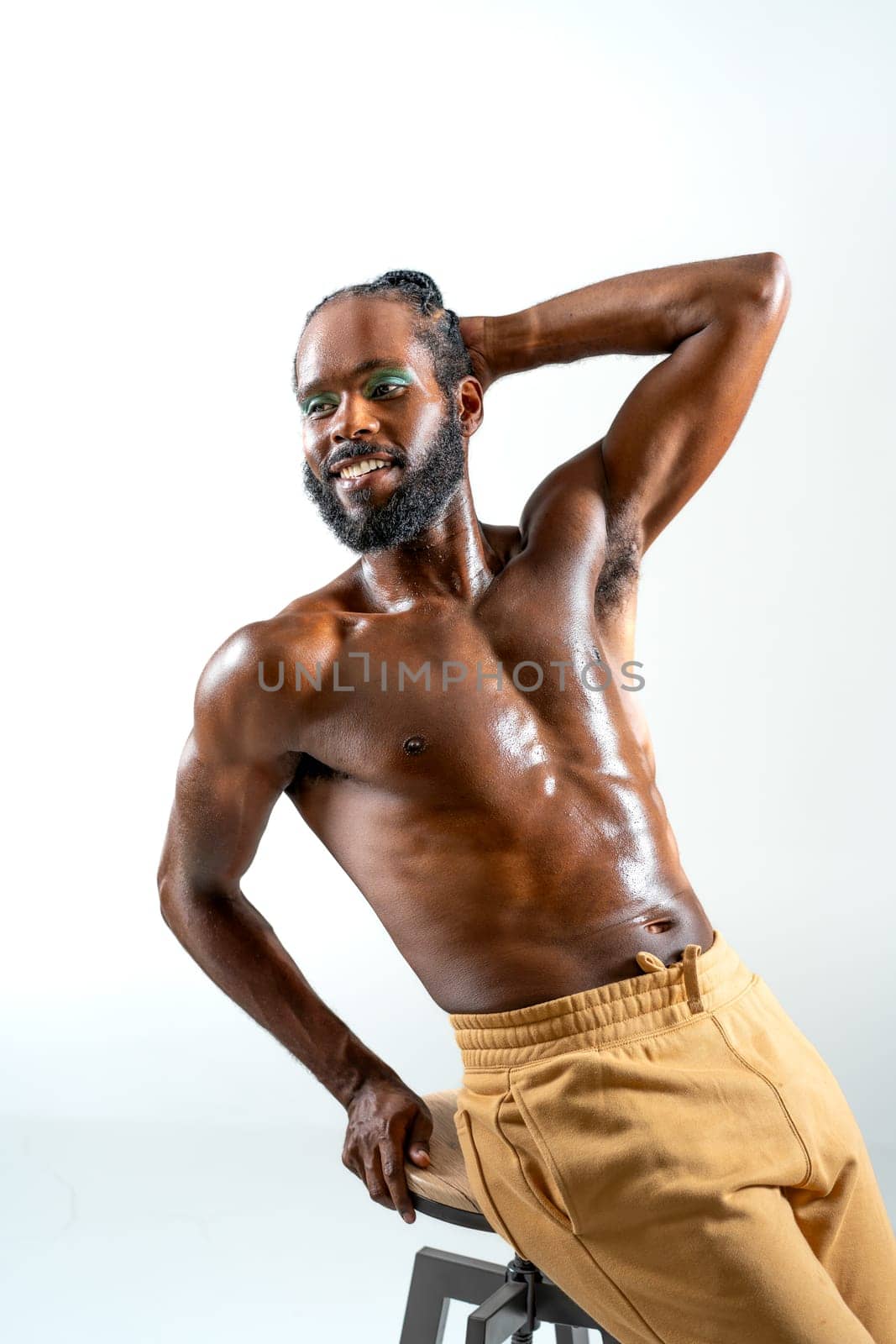 Happy african-american bearded gay man with bright makeup isolated on white background. Exudes sense of pride and individuality. Diversity power of personality.