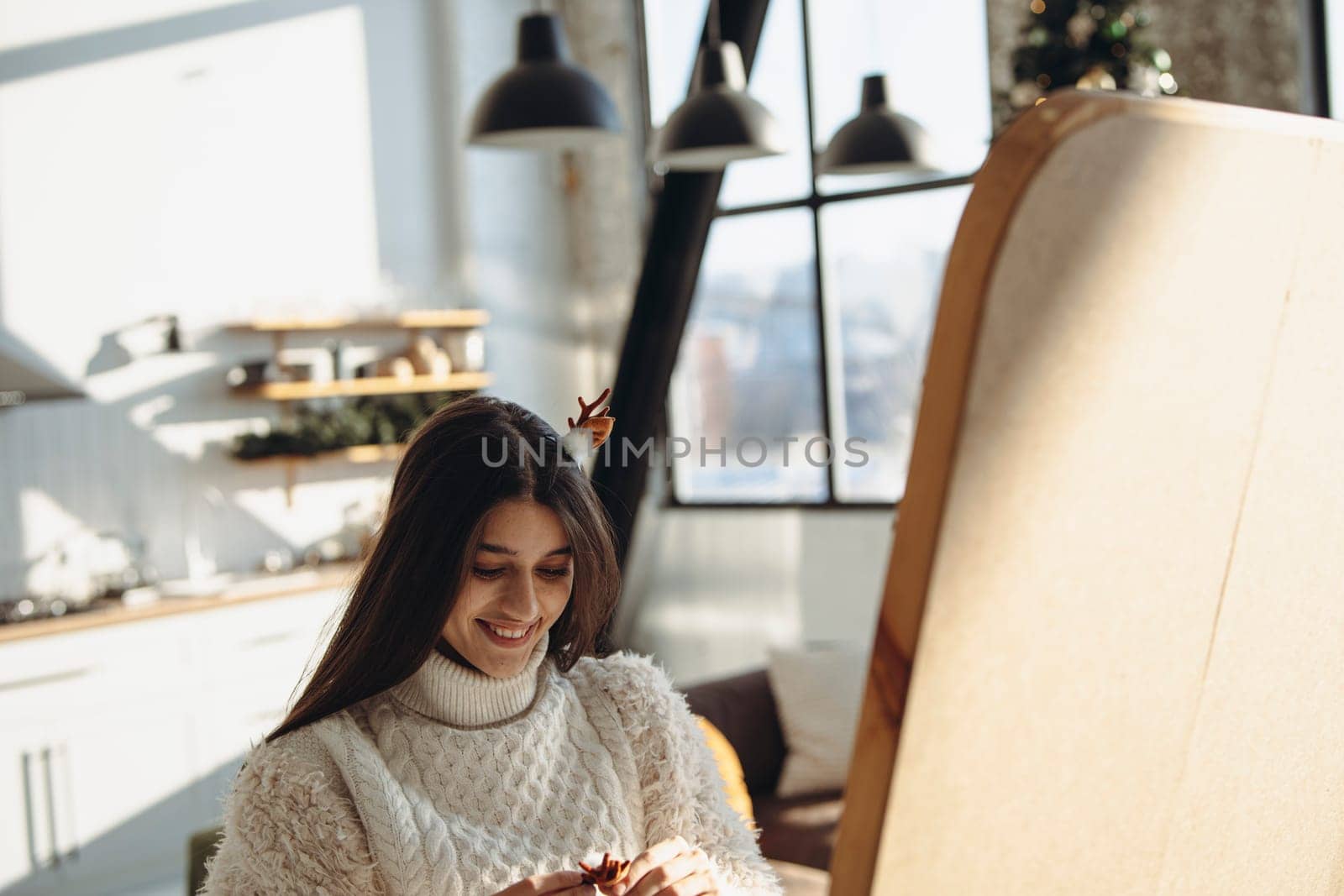 Embracing the Christmas celebration, a vibrant young lady perfects her hairstyle at home. High quality photo