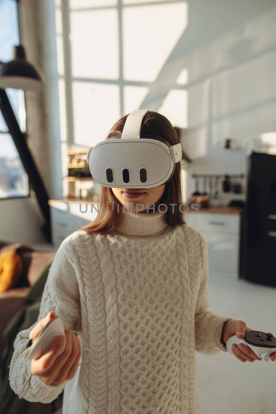 A lovely young lady wearing a virtual reality headset talks about her impressions. High quality photo