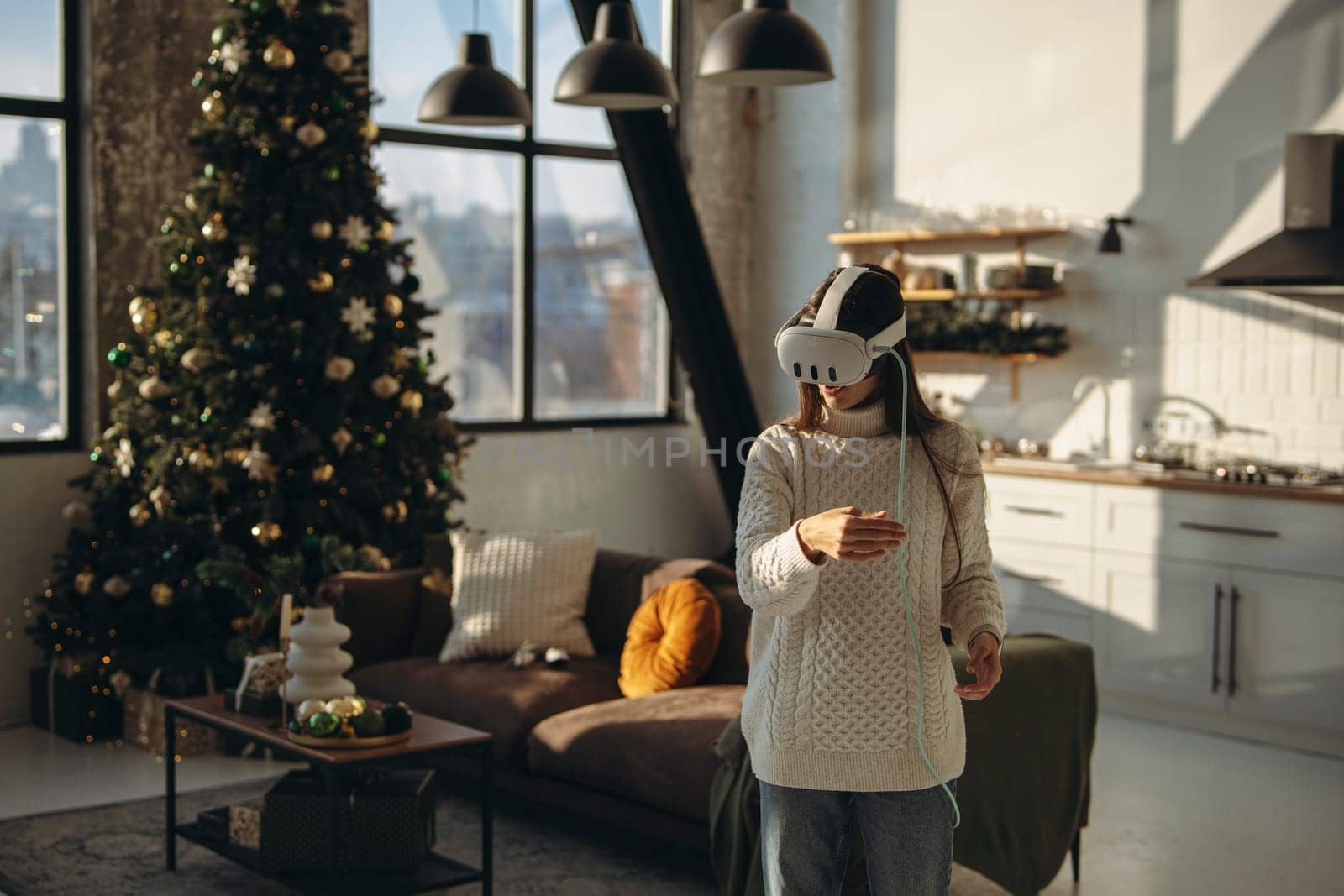 A young lady, absorbed in an online game, wears a virtual reality headset in her apartment. High quality photo