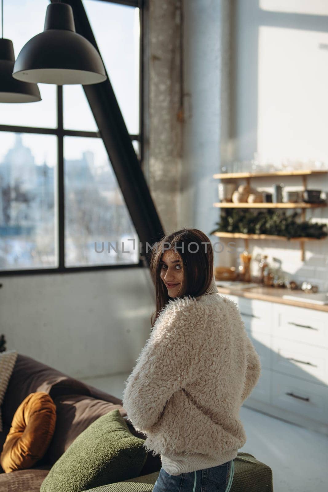 An active young woman in a virtual reality headset in a sunlit apartment. High quality photo