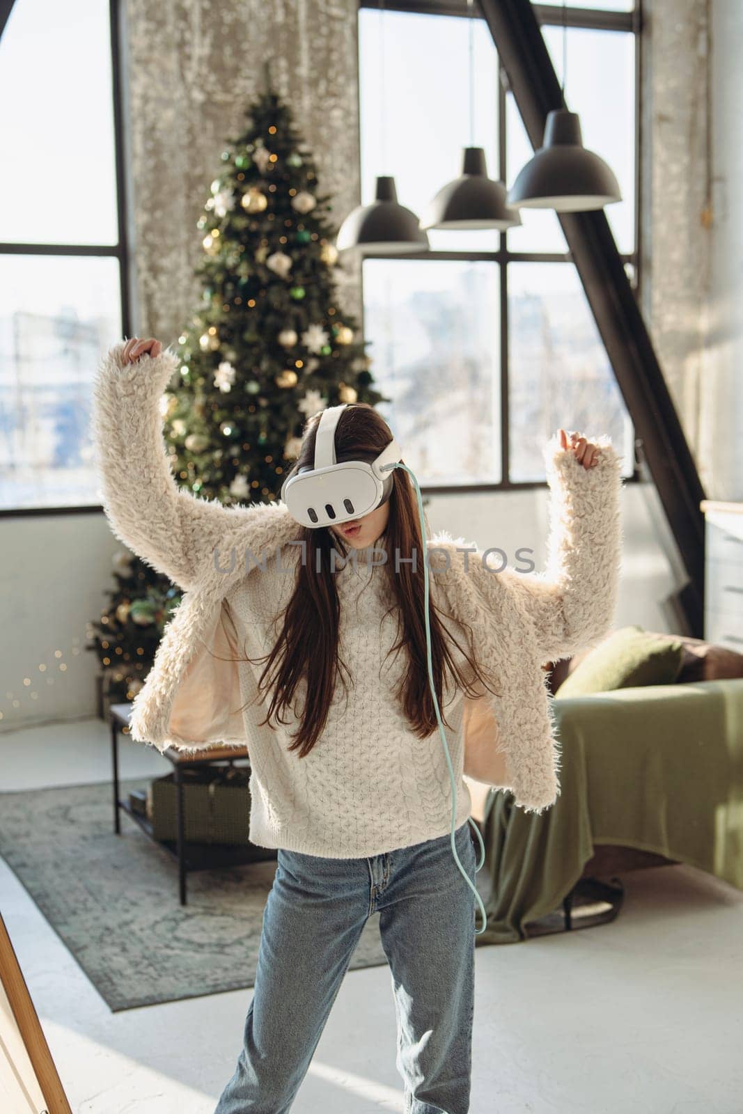 In the ambiance of a Christmas tree, a stunning young woman experiences virtual reality. High quality photo