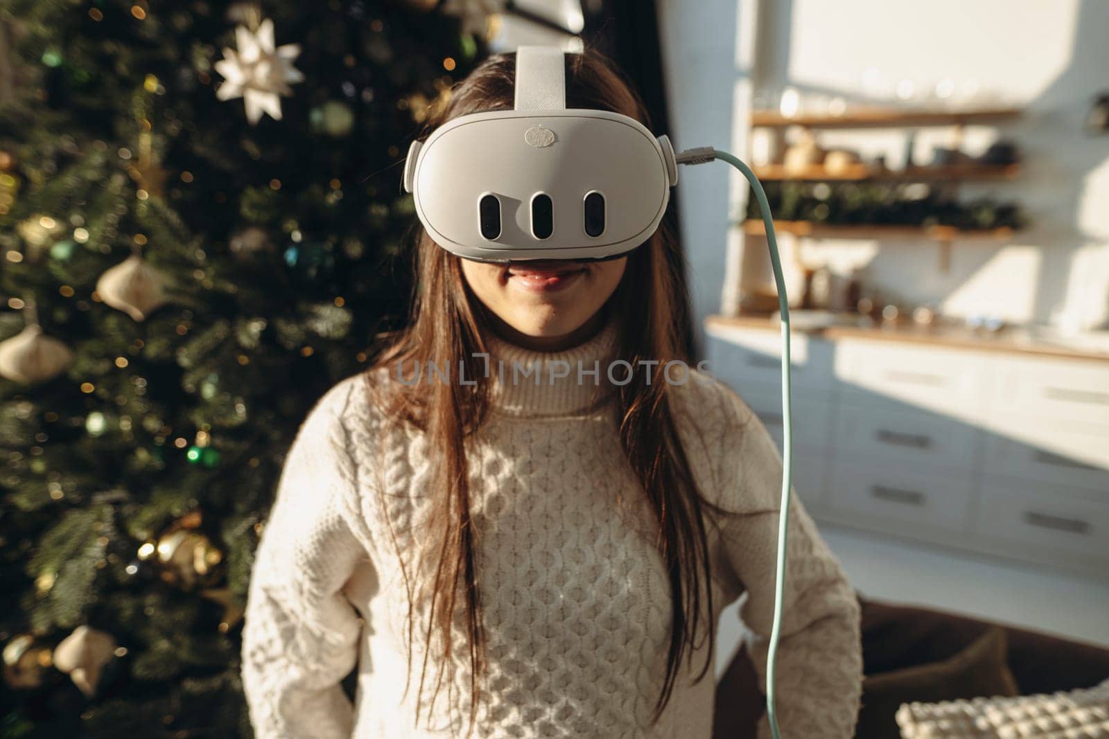Surrounded by sunshine on a winter morning, a lively young woman wears a VR headset. High quality photo