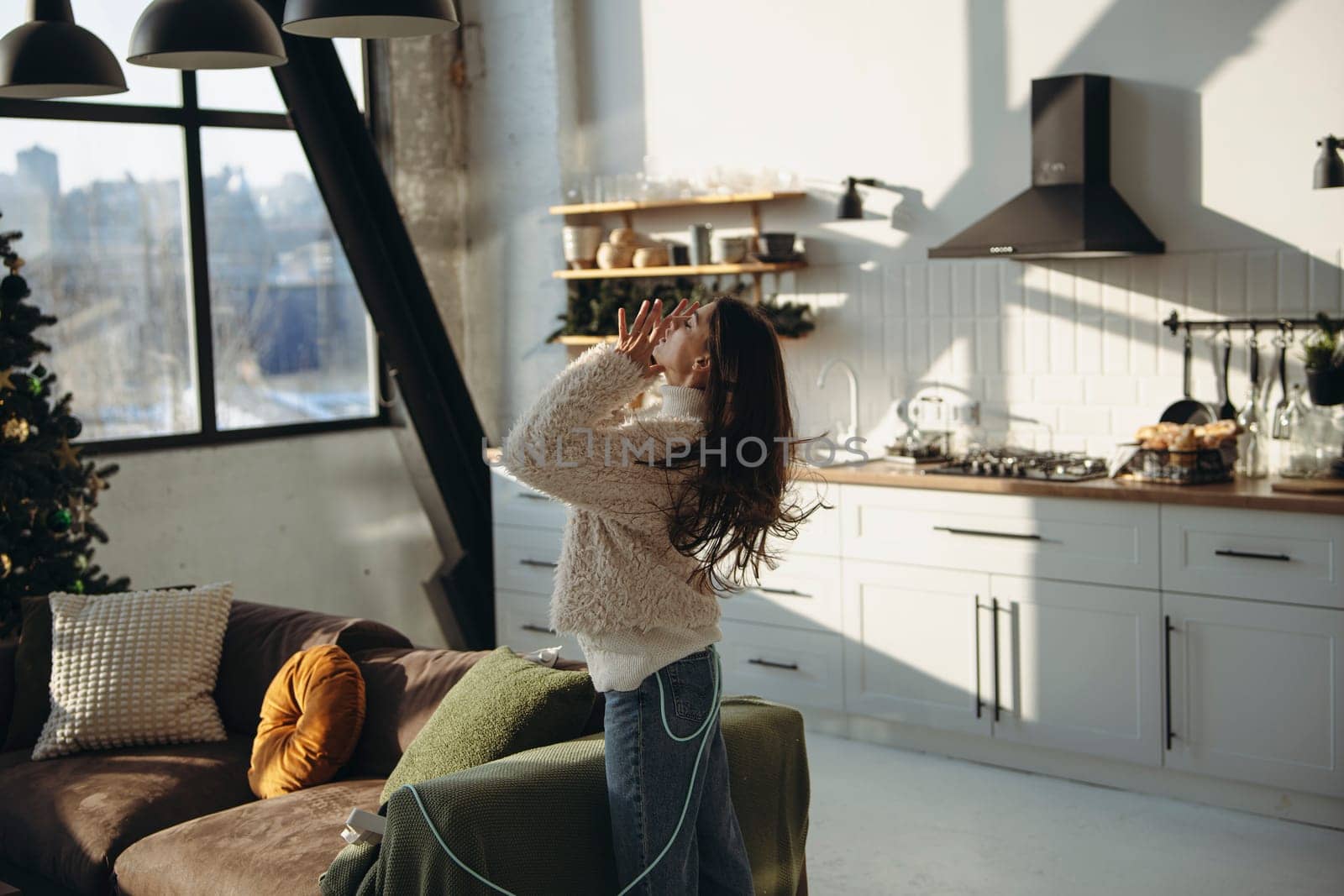 An active young woman in a virtual reality headset in a sunlit apartment. High quality photo