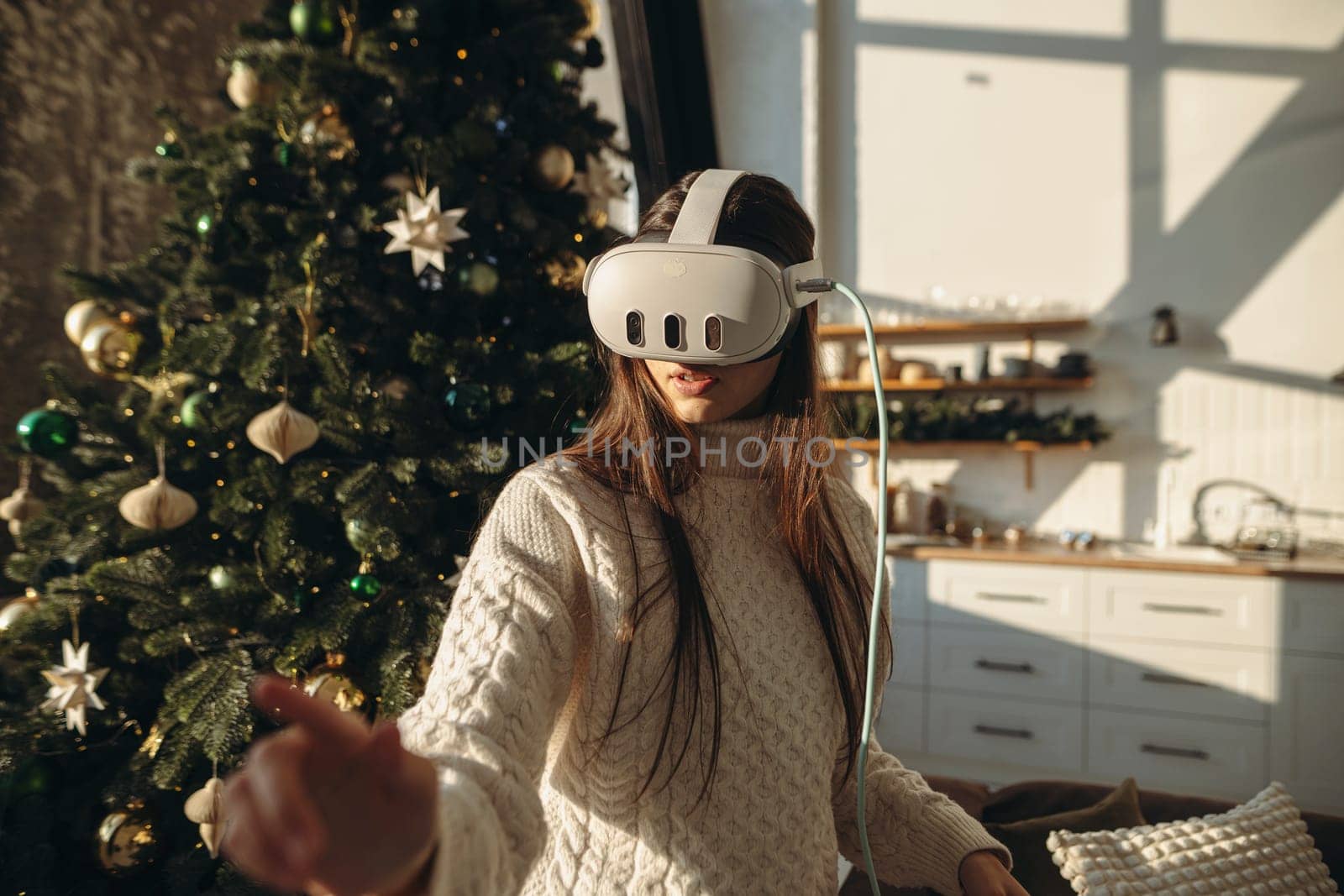 An enchanting portrait of a girl with a VR headset, set against the festive scene of a Christmas tree. High quality photo