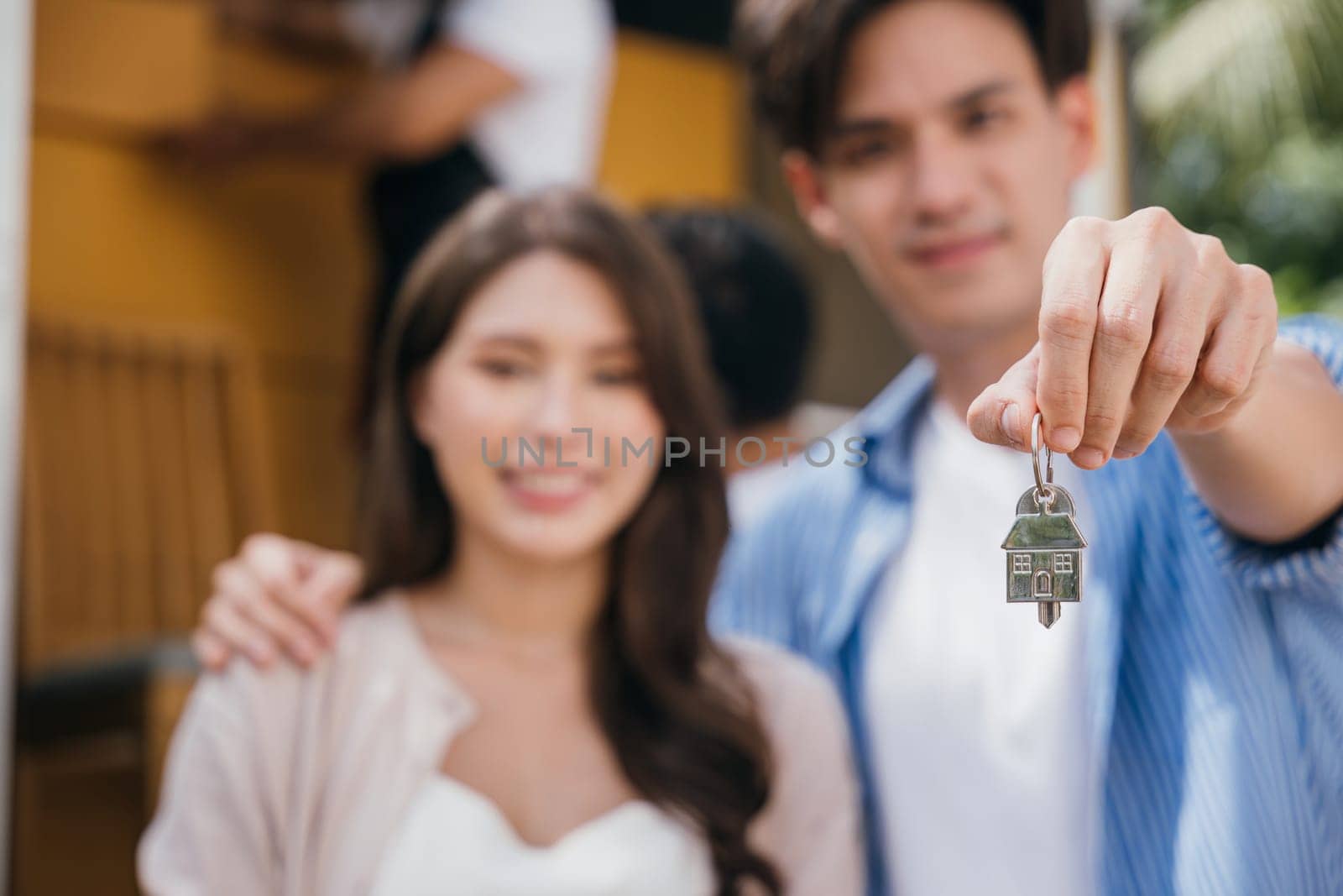In a moment of success a couple holds keys carrying a mattress into their new home. A joyous relocation captures their happiness. Moving Day Concept by Sorapop