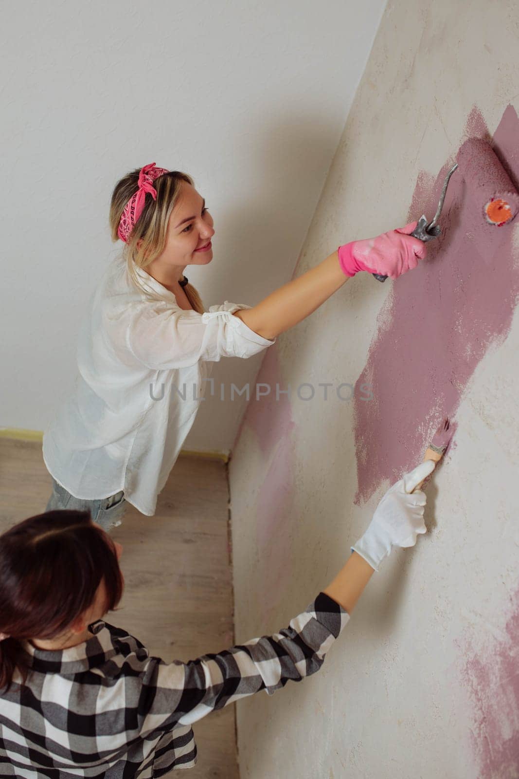 Sexy girl designer eats sushi on the construction site. painter has lunch after work. Concept interior design and room repair.