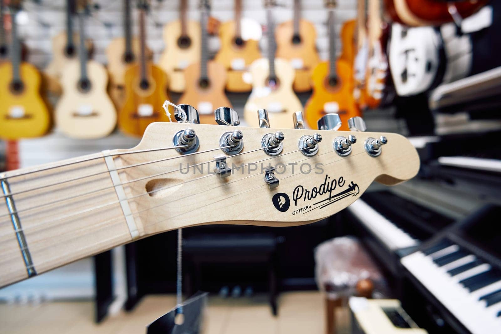 Ryazan, Russia - January 9, 2024: Headstock of an electric guitar made by Prodipe Guitars, close-up