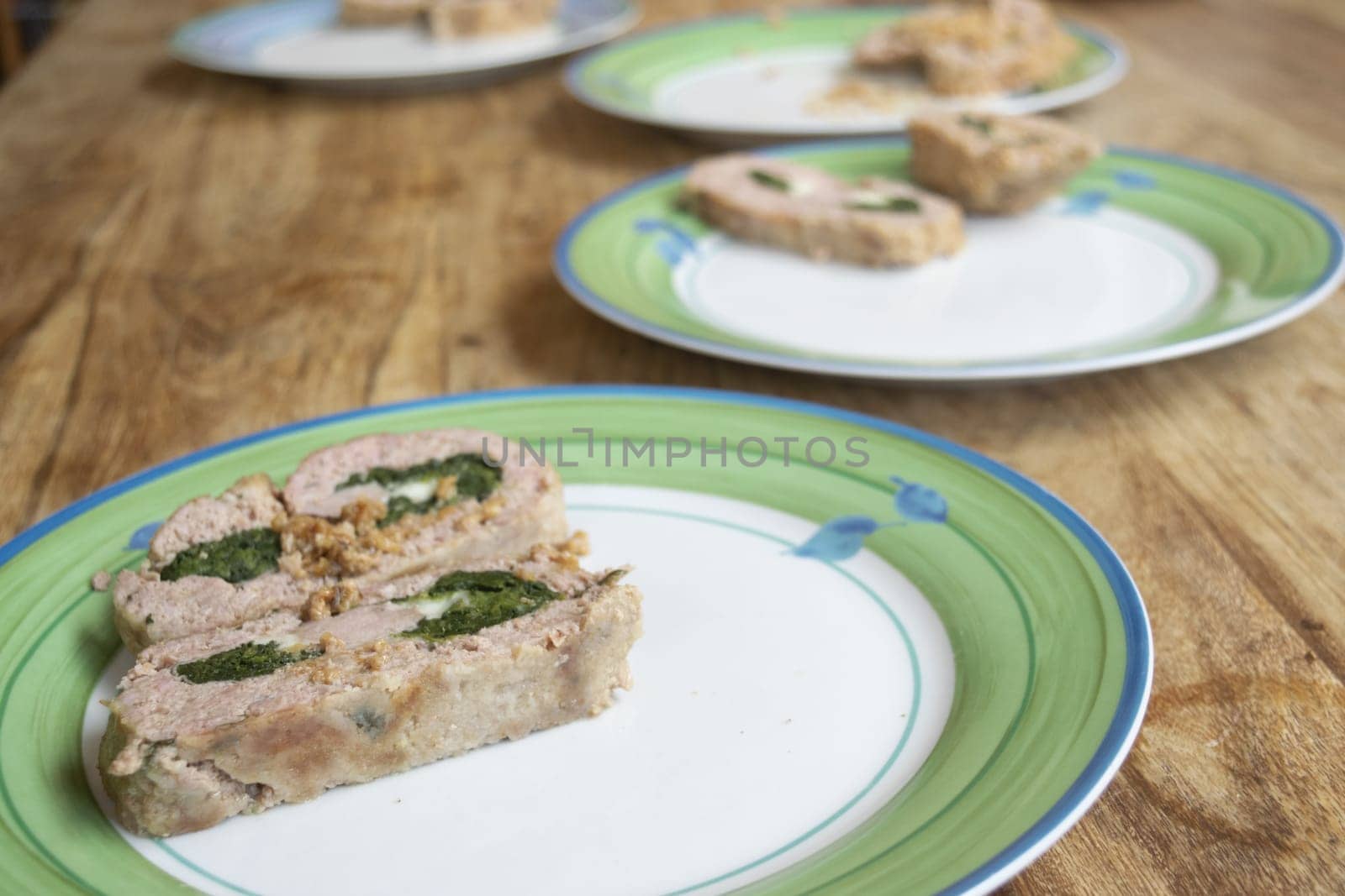 plates lined up with spinach meatloaf inside