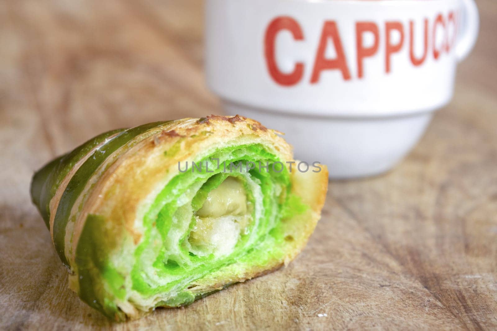 morning awakening with cappuccino and half pistachio croissant  