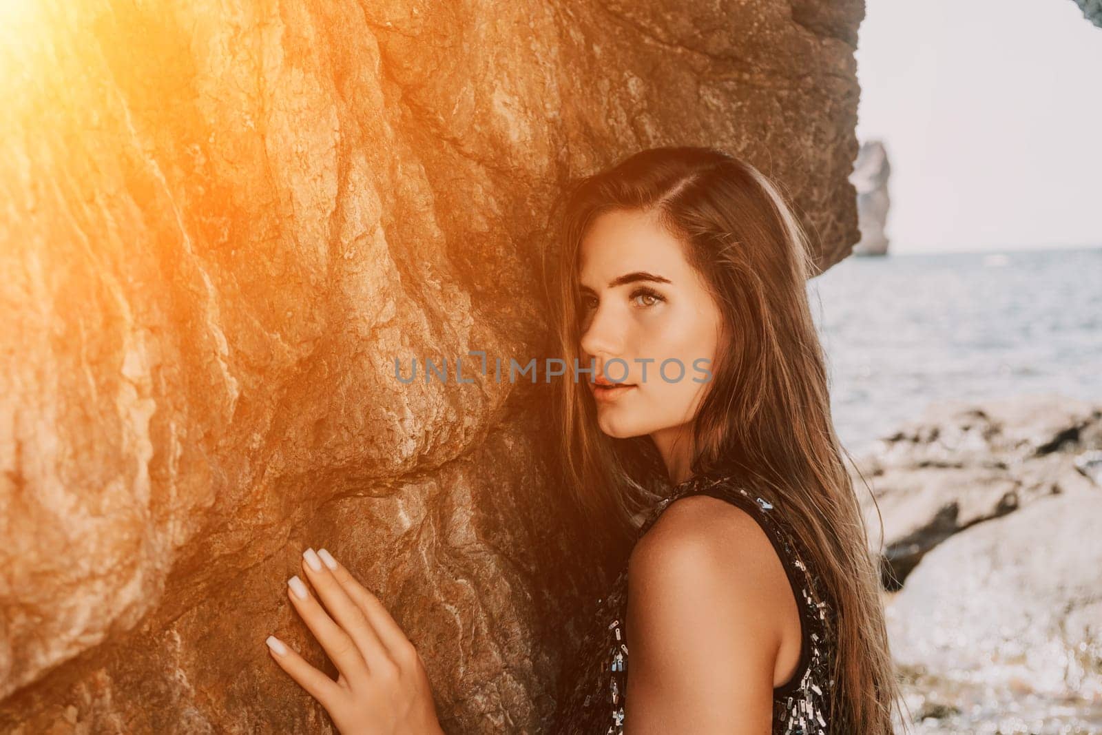 Woman summer travel sea. Happy tourist enjoy taking picture outdoors for memories. Woman traveler posing on the beach at sea surrounded by volcanic mountains, sharing travel adventure journey by panophotograph