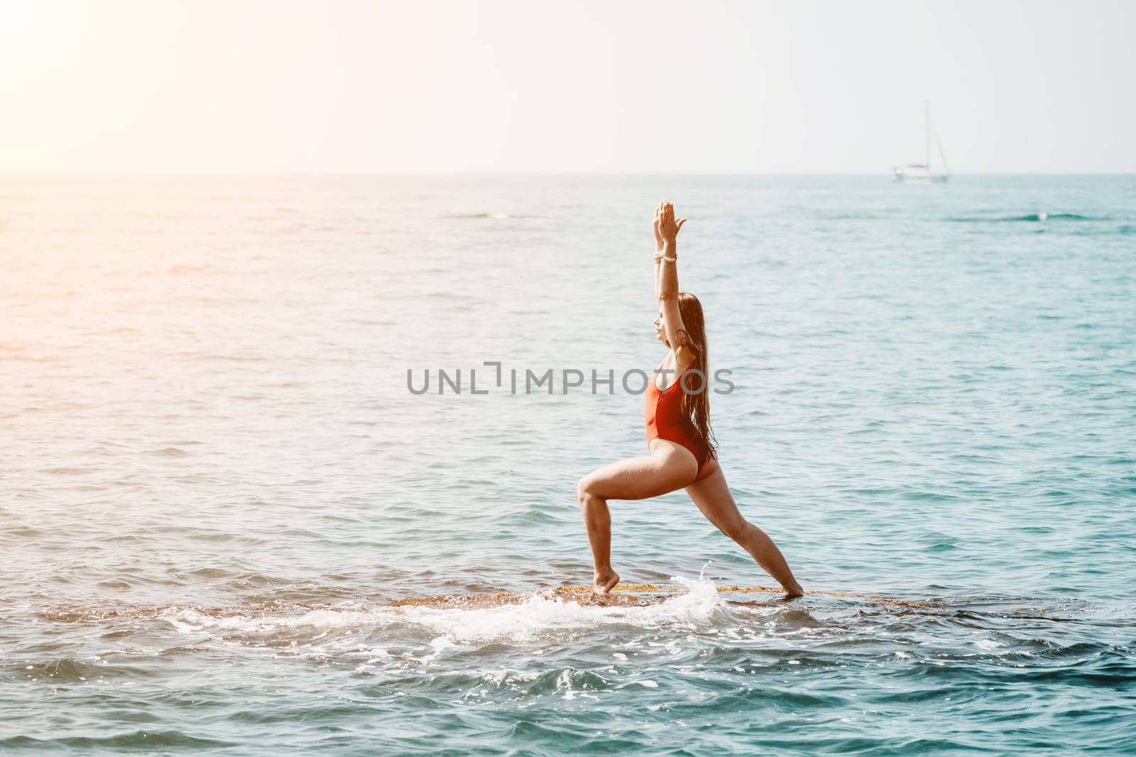 Woman sea yoga. Back view of free calm happy satisfied woman with long hair standing on top rock with yoga position against of sky by the sea. Healthy lifestyle outdoors in nature, fitness concept.