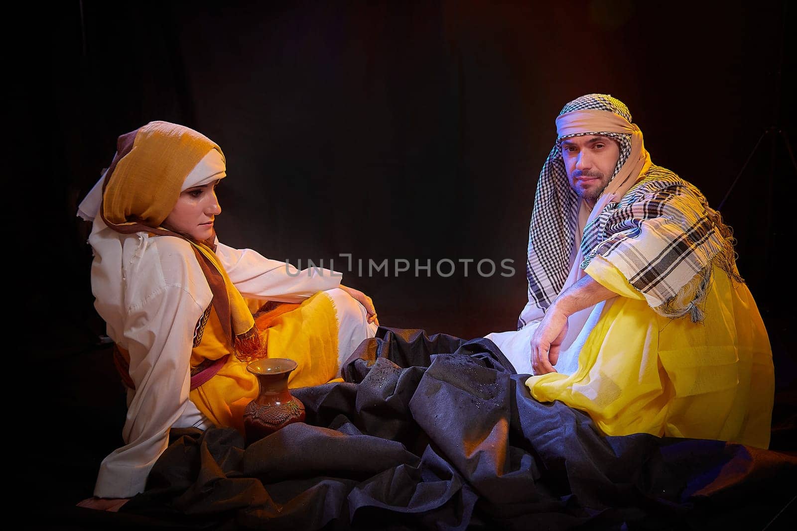 A couple in love or a married couple in stylized Eastern clothing from Israel, Palestine, Iran, Pakistan together. Tender photo session in the style of the Middle East and the Bible