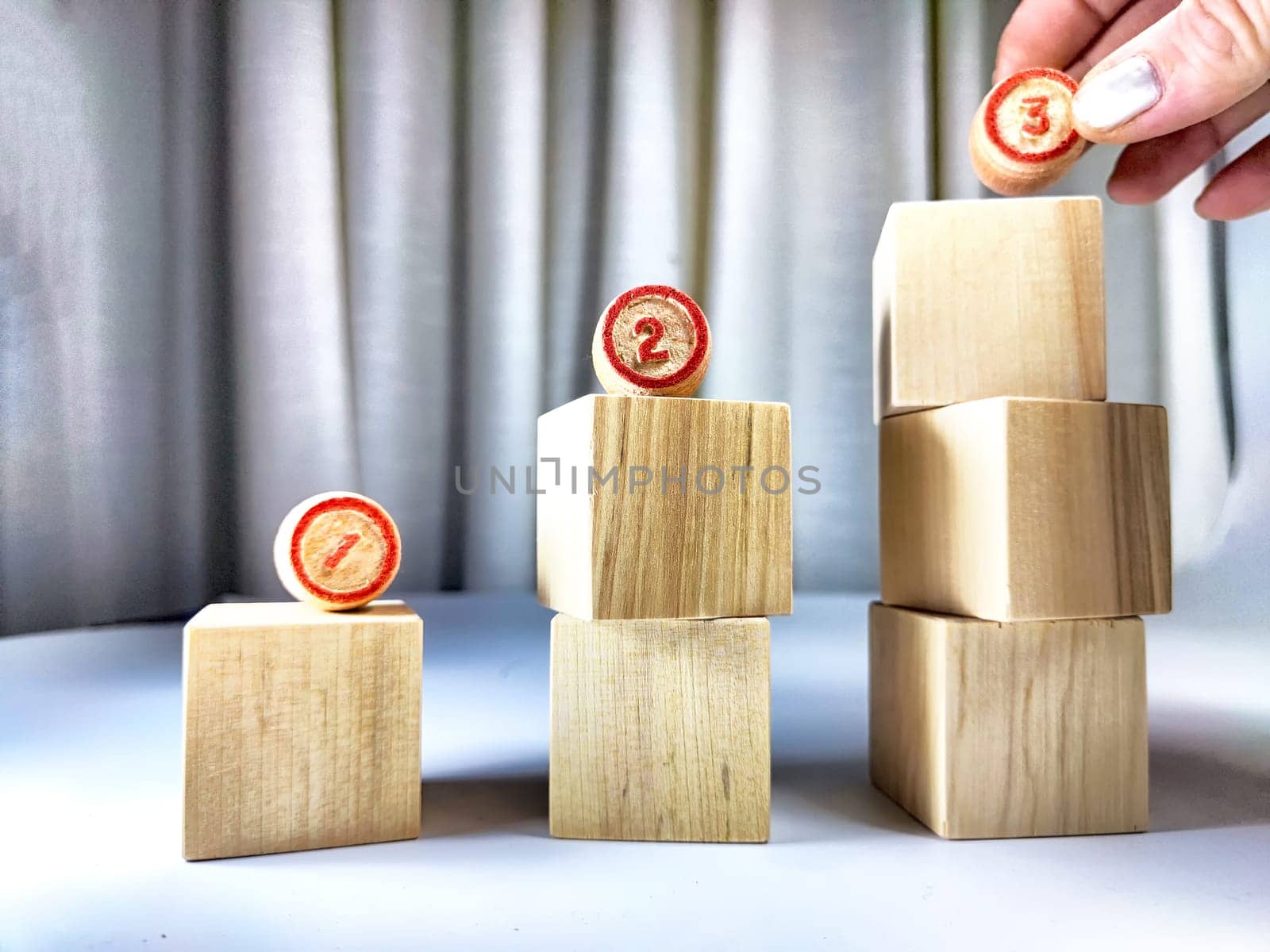 Small wooden cubes in columns, lined up in a row. The concept of progressive movement in achieving the goal. Steps and stages of project development and implementation