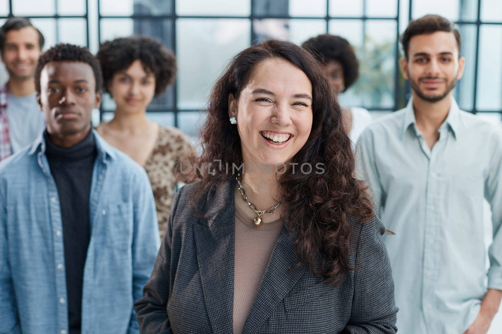 business woman with her staff in background at office by Prosto