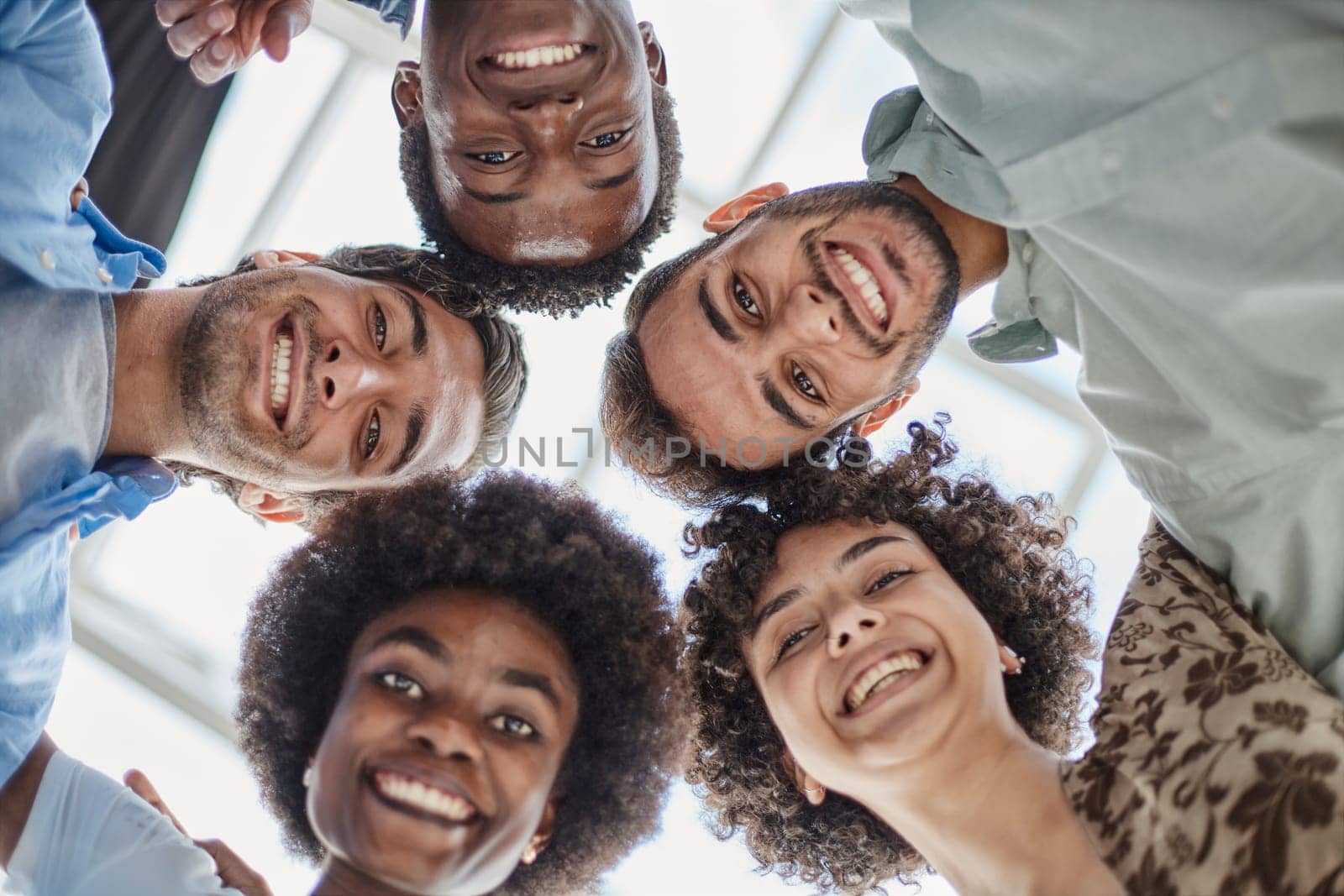 Closeup portrait, bottom view, happy faces of different team employees standing in circle by Prosto