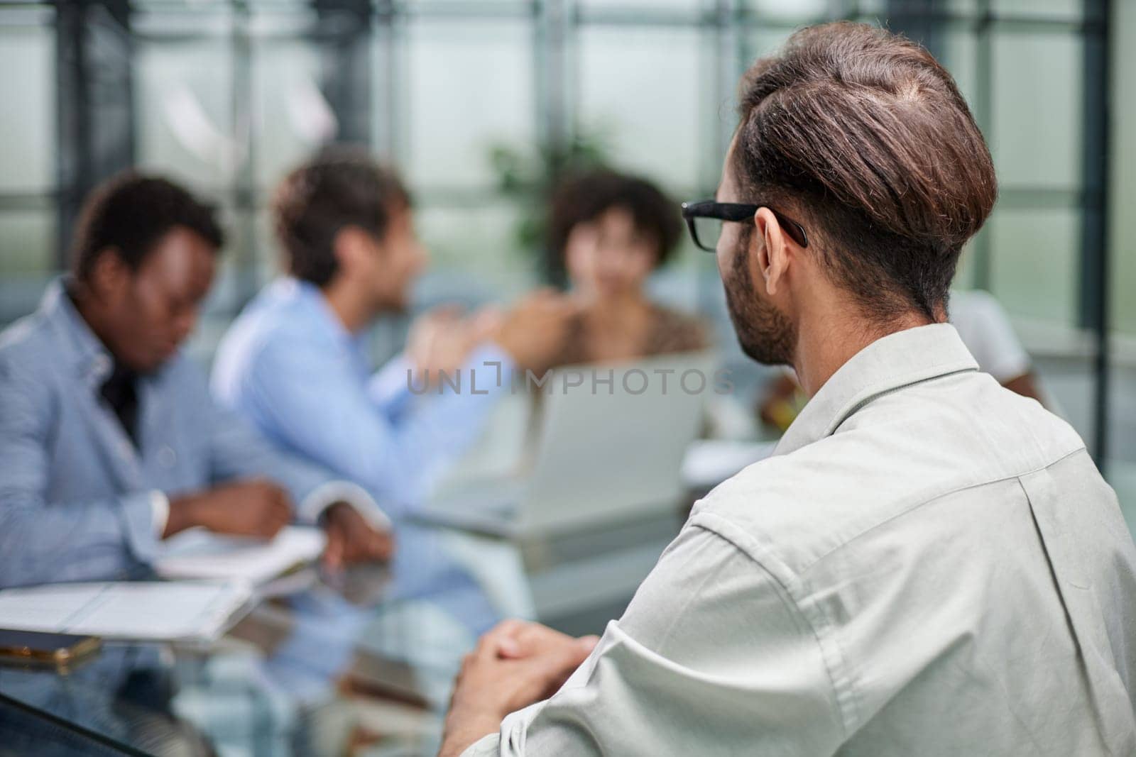 business man with executives working in background in office