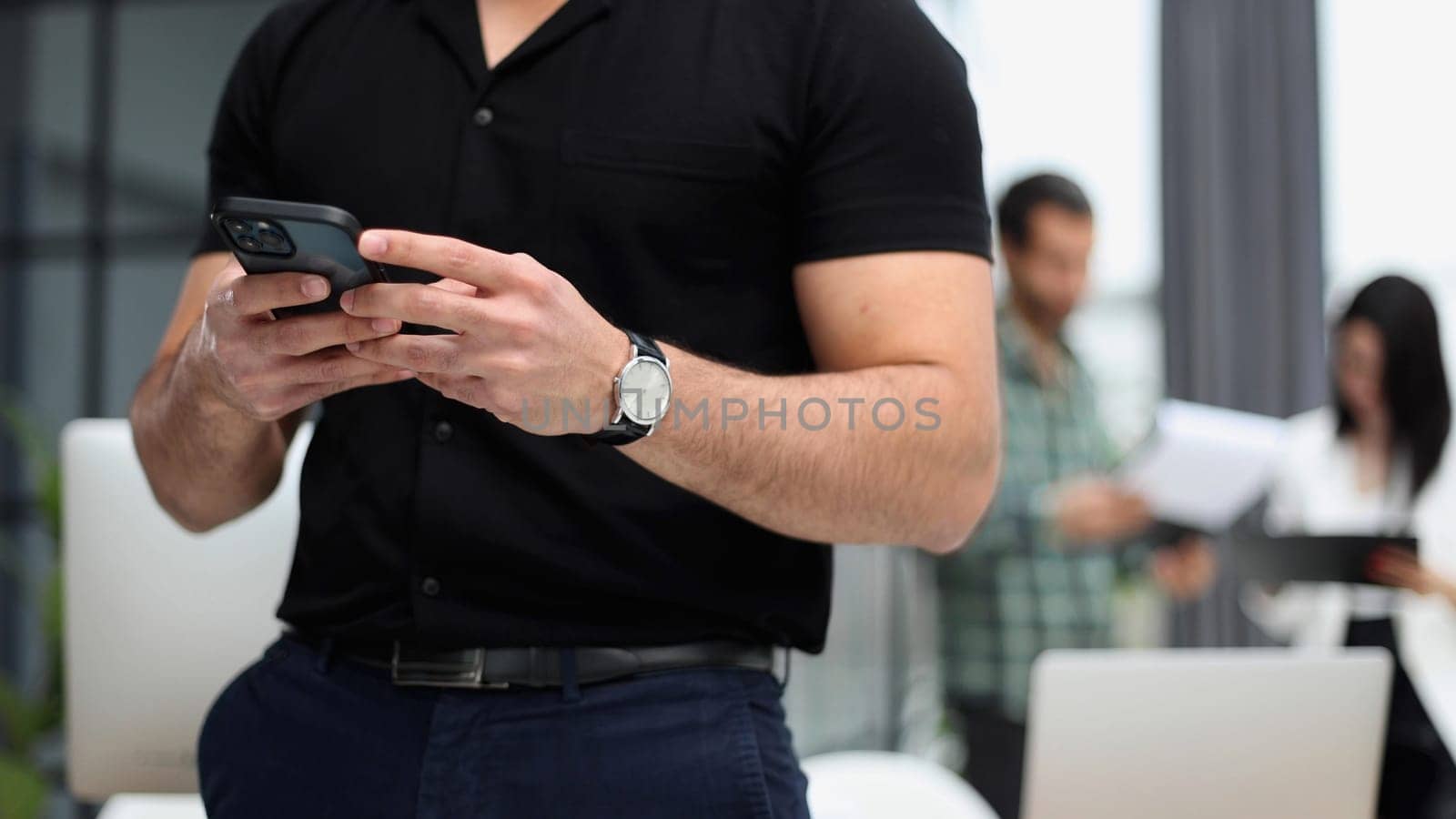 Close-up of a smartphone screen in the hands of a businessman. by Prosto