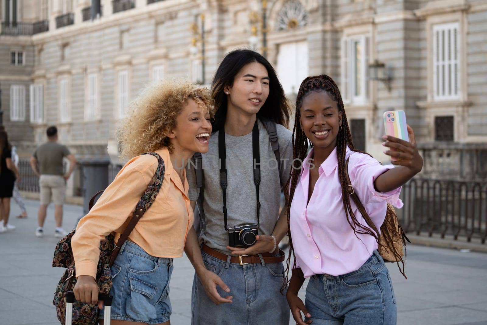 Multiethnic group of tourists friends taking a selfie in Madrid city.
