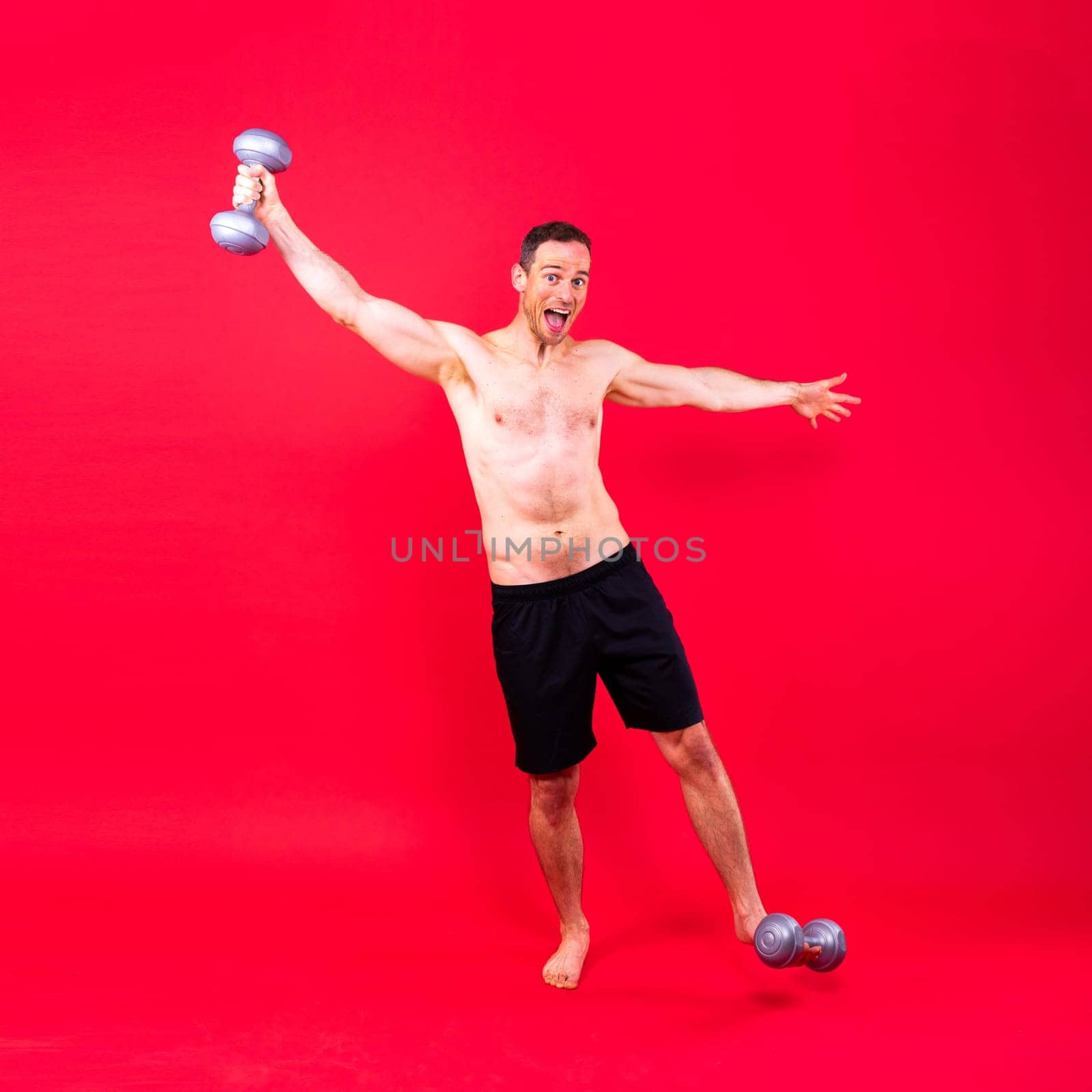 Man, dumbbell and exercise in studio for fitness, wellness and healthy body with workout training. by Zelenin