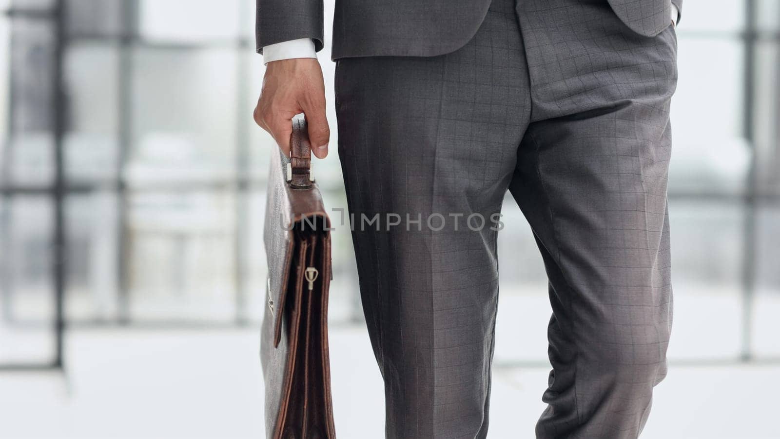 modern businessman with briefcase in modern office by Prosto