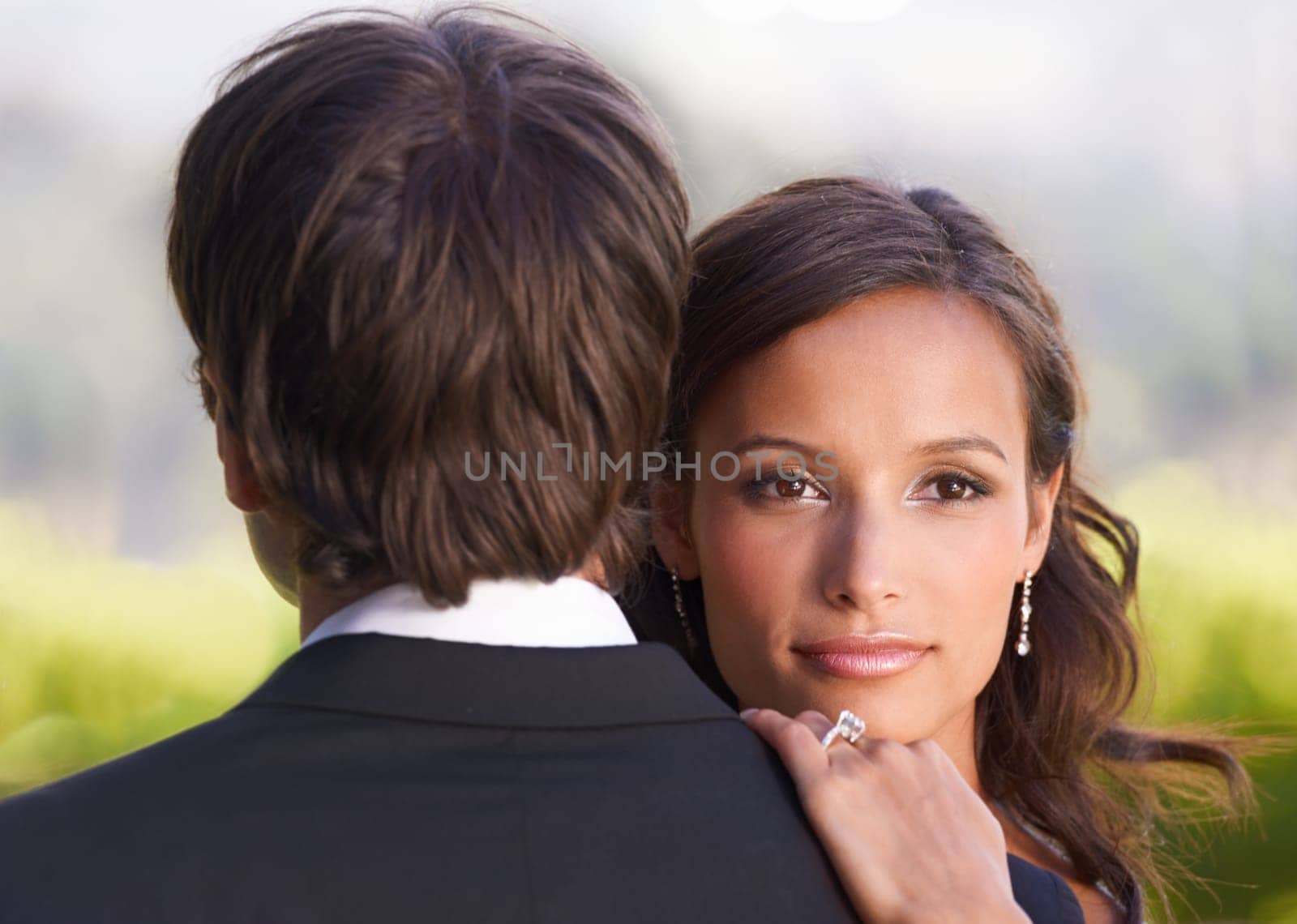 Bride, portrait and hug on wedding day for love, support and excited for marriage and commitment. Happy couple, romance and embrace at outdoor ceremony, loyalty and pride for ring and partnership.