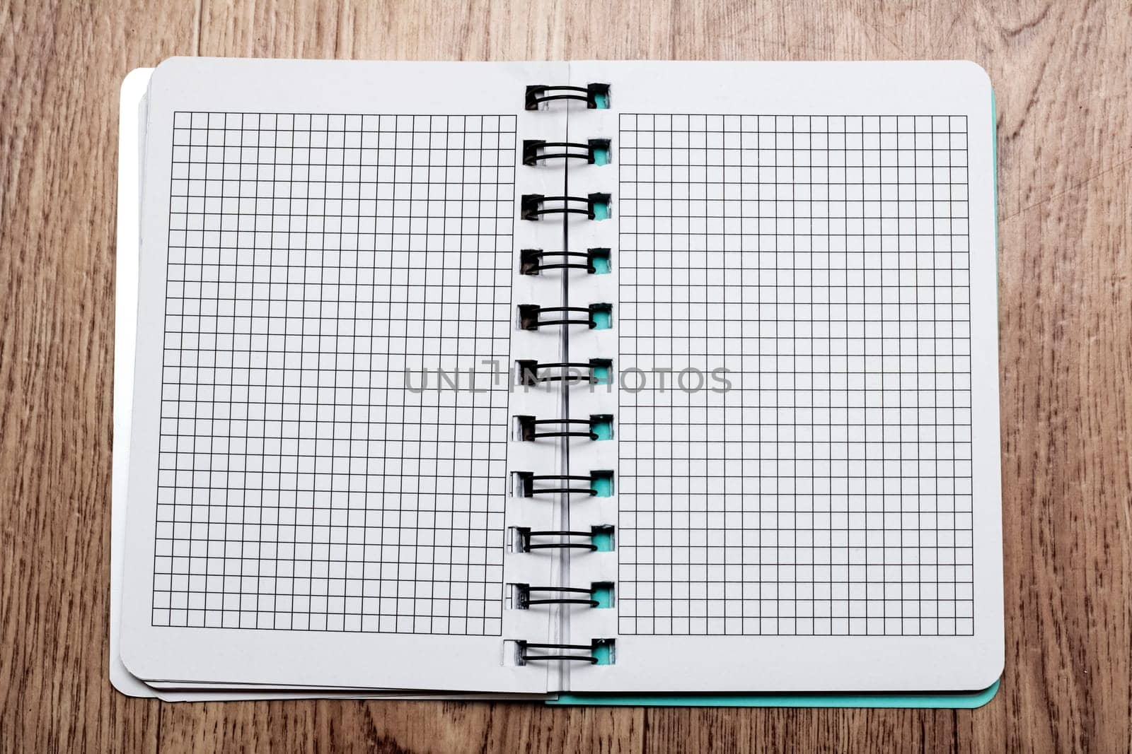 Open notebook with blank pages close up on wooden table