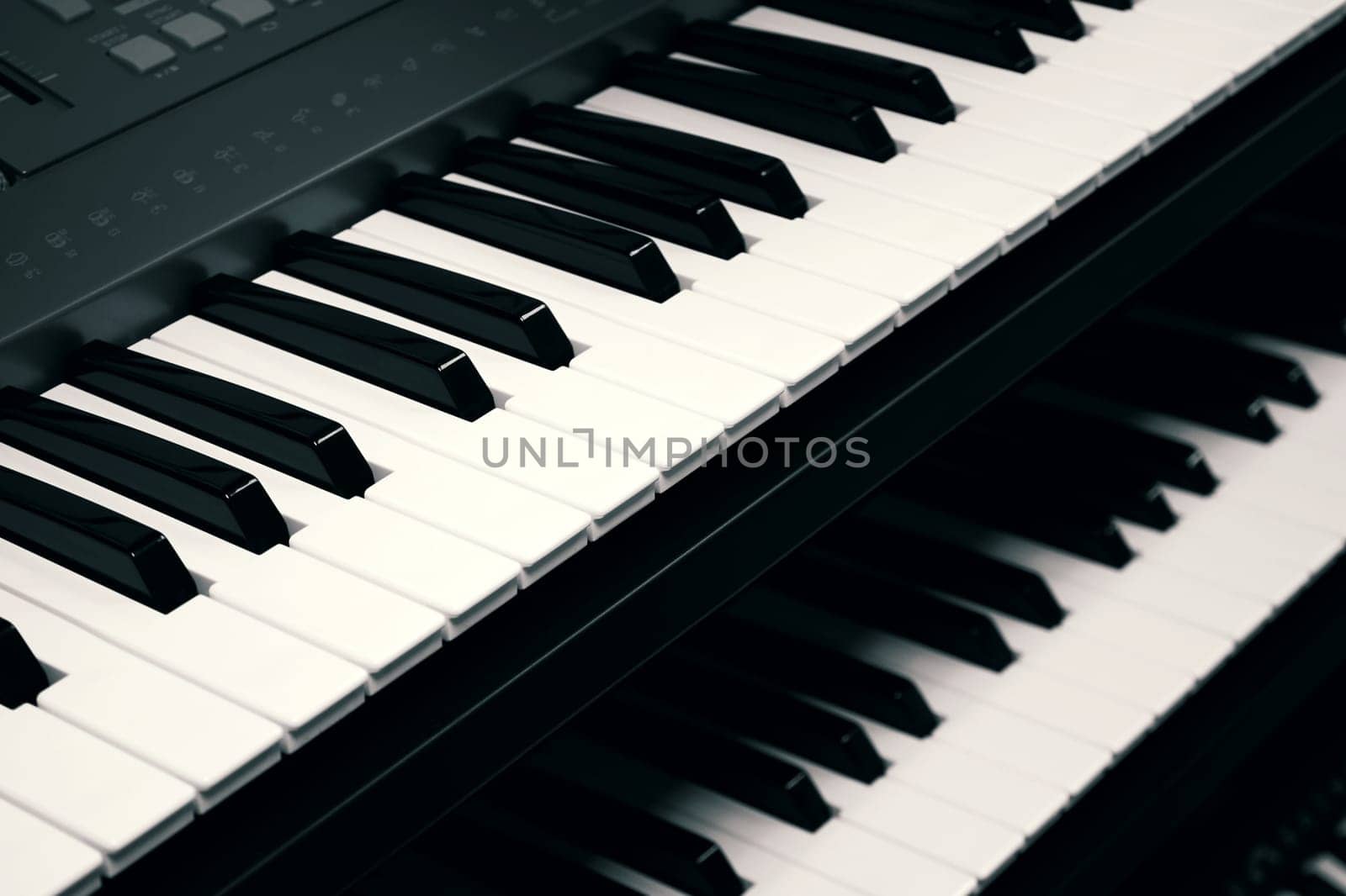 Digital piano keyboards close up, toned in black and white