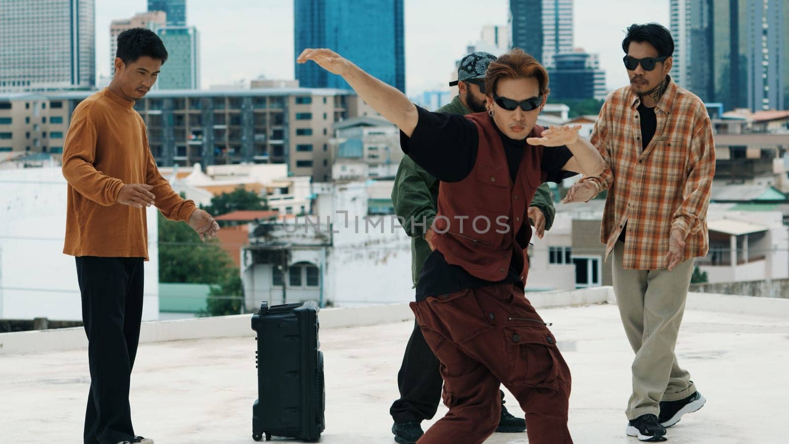 Hispanic hipster dancing surrounded by multicultural friend at city view with blue sky. Group of street dancer performing at rooftop. Active, fun, happy atmosphere. Outdoor sport 2024. Endeavor.