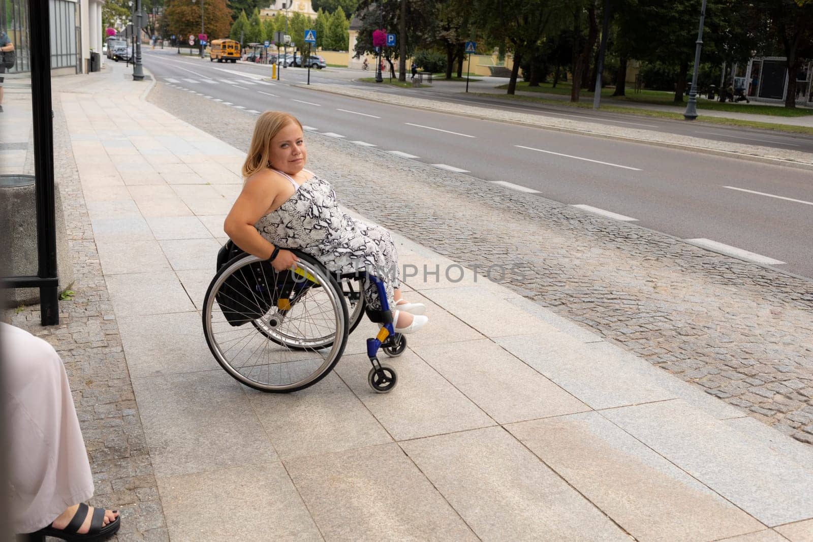 International Wheelchair Day. Person With Short Stature On Wheelchair Waiting For Public Transport On Bus Stop Outdoor. Female Adult With Disability. Copy Space For Text. Transportation