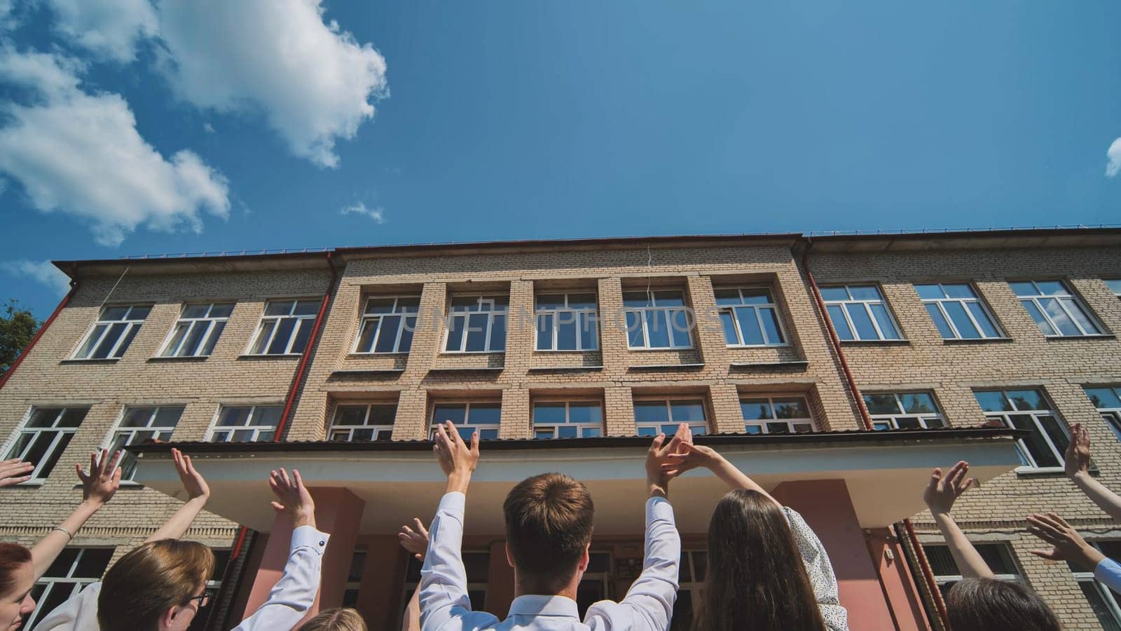 Graduates say goodbye to the school and wave goodbye. by DovidPro