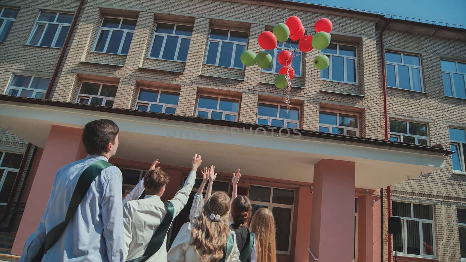 Berezovka, Belarus - May 31, 2023 High school graduates launch balloons into the sky