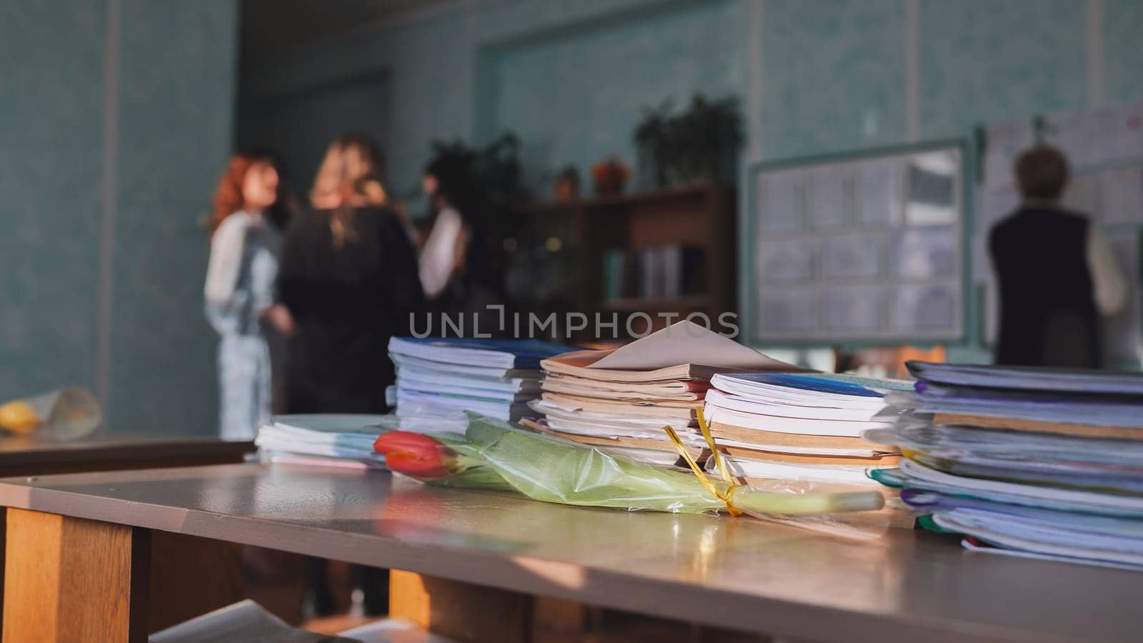 Stacks of books and notebooks in a school classroom during recess. by DovidPro