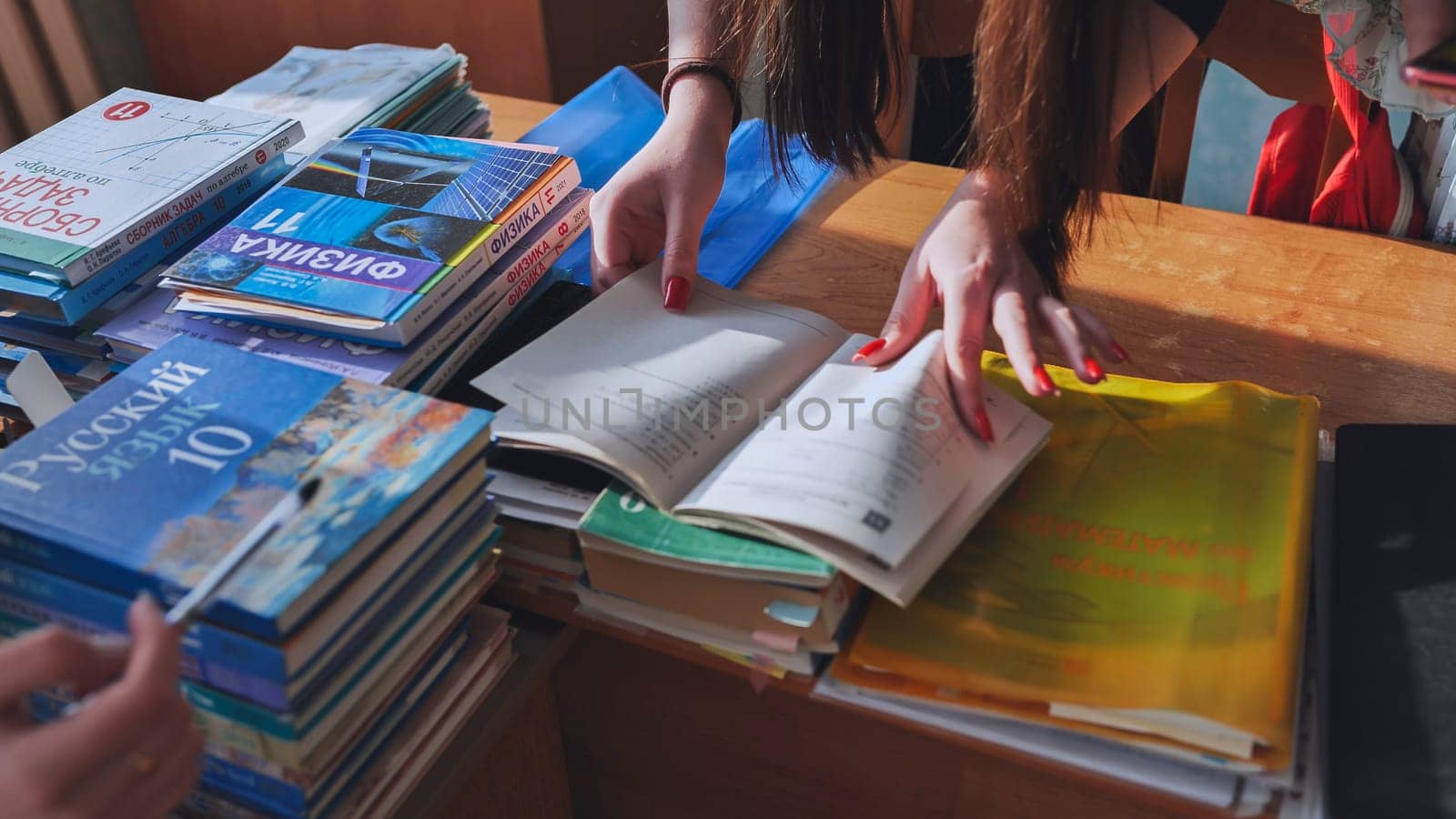 Russian students search for information in a teacher's secret book. by DovidPro
