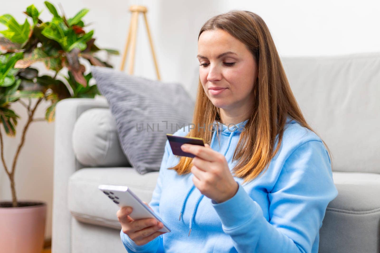 Woman Shopping Online with Credit Card and Phone by andreyz