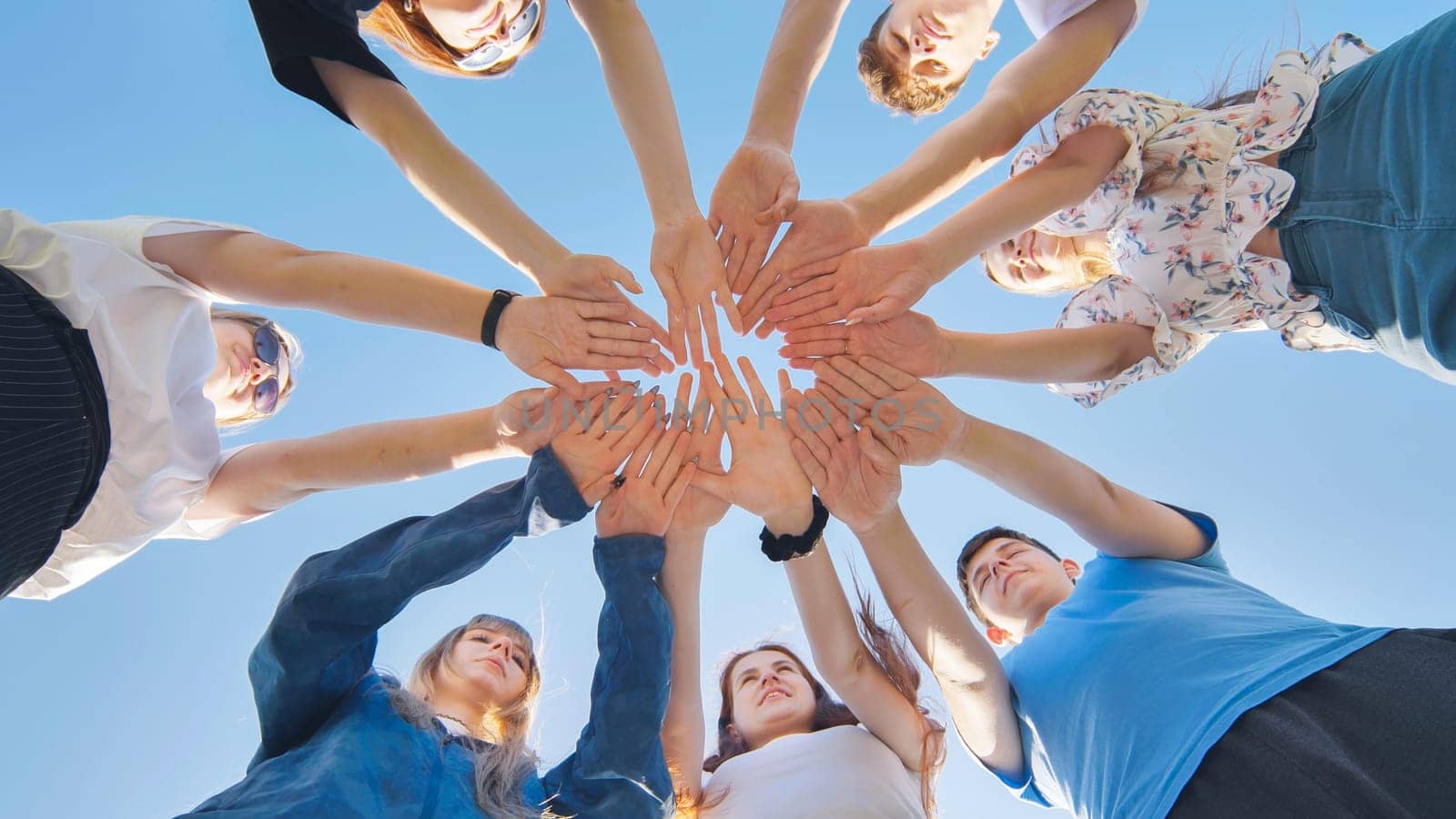 Friends putting their hands together in a sign of unity and teamwork. Just the hands