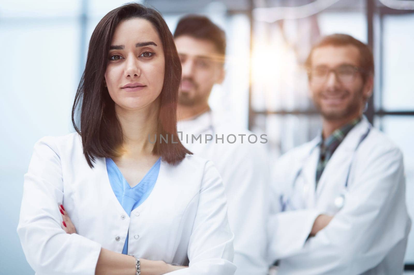 Attractive female doctor in front of medical stuff in hospital by Prosto