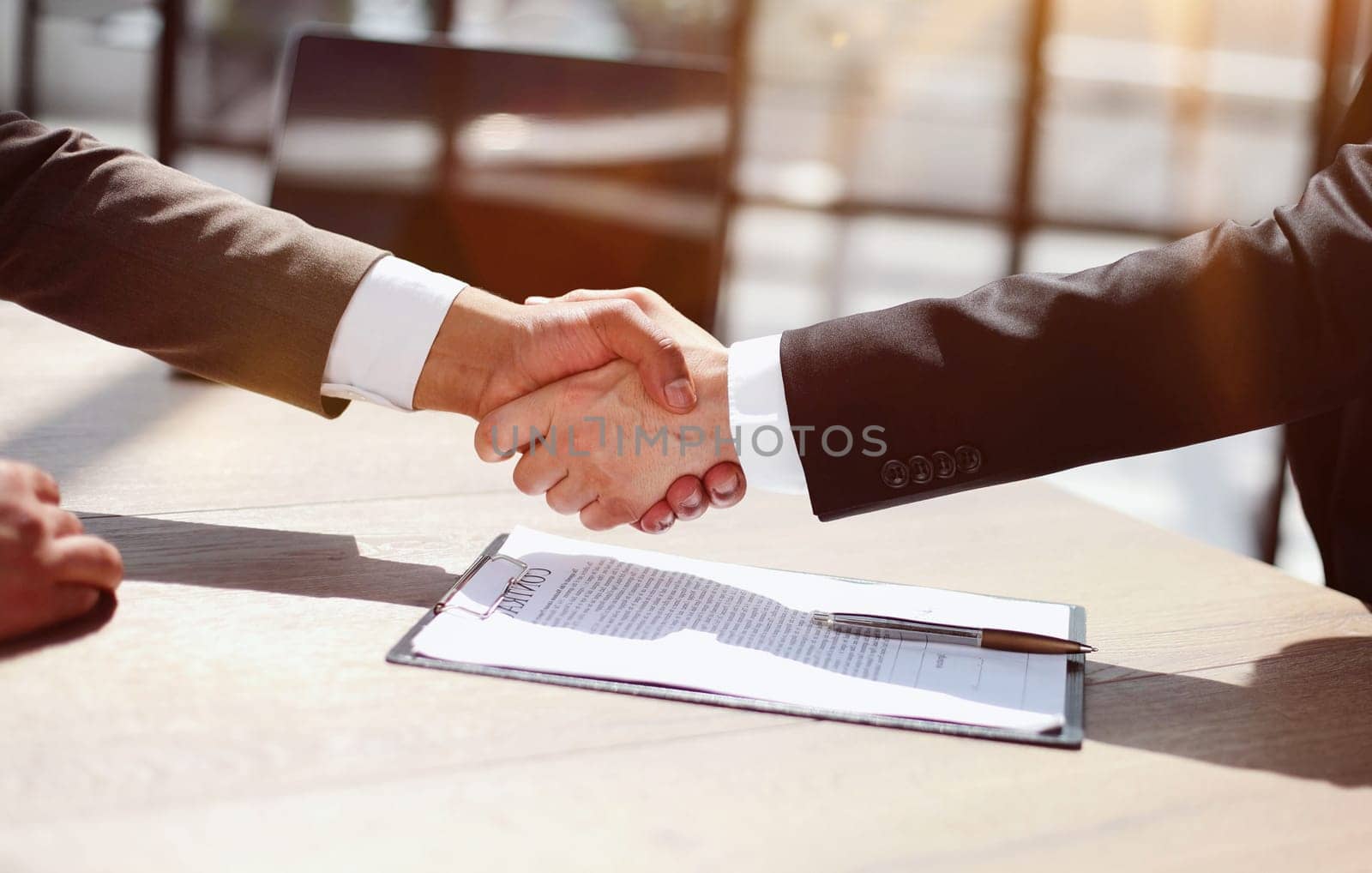 Business shaking hands, finishing up meeting. Successful businessmen handshaking after good deal. by Prosto