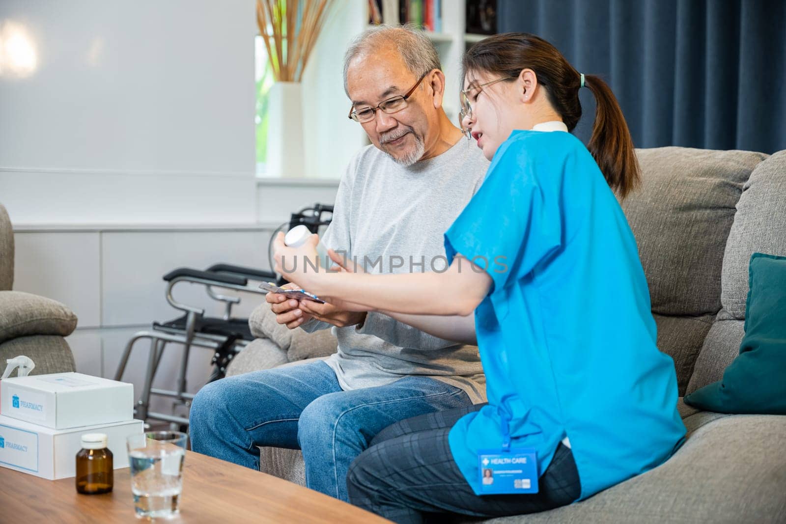 Asian doctor with physician visit senior male patient consult medicine dosage at house in living room, Woman nurse caregiver showing prescription drug to senior man at nursing home, healthcare support