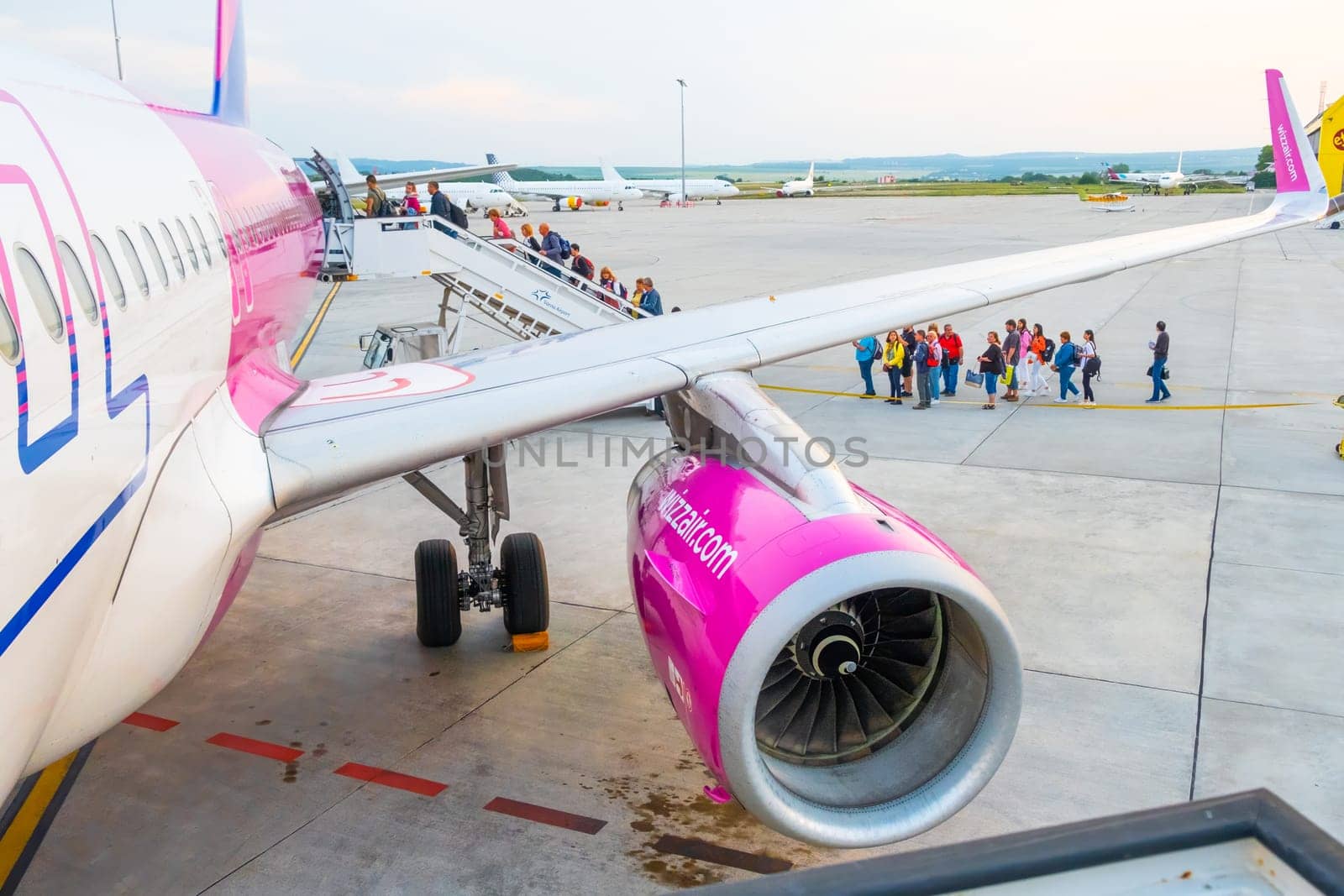 Wizzair airplane turbine and people boarding the plane by vladimka