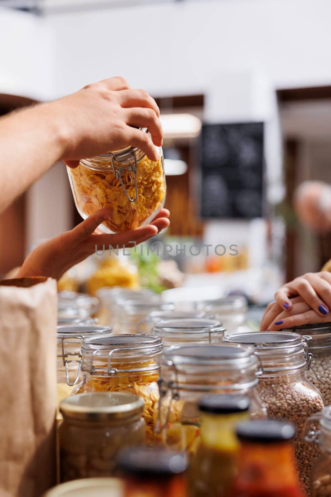 Storekeeper helping client looking for eco friendly cereals in local neighborhood shop. Seller offering customer information about product in sustainable zero waste supermarket, close up