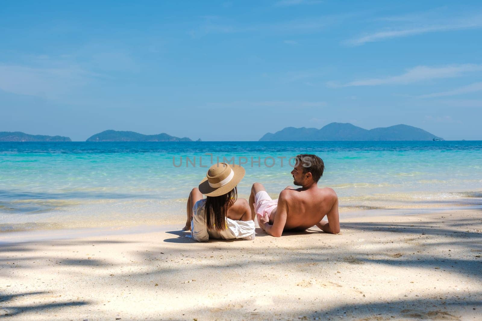 a young couple of men and women on a tropical beach during a luxury vacation in Thailand, tropical Island Koh Wai Trat Thailand