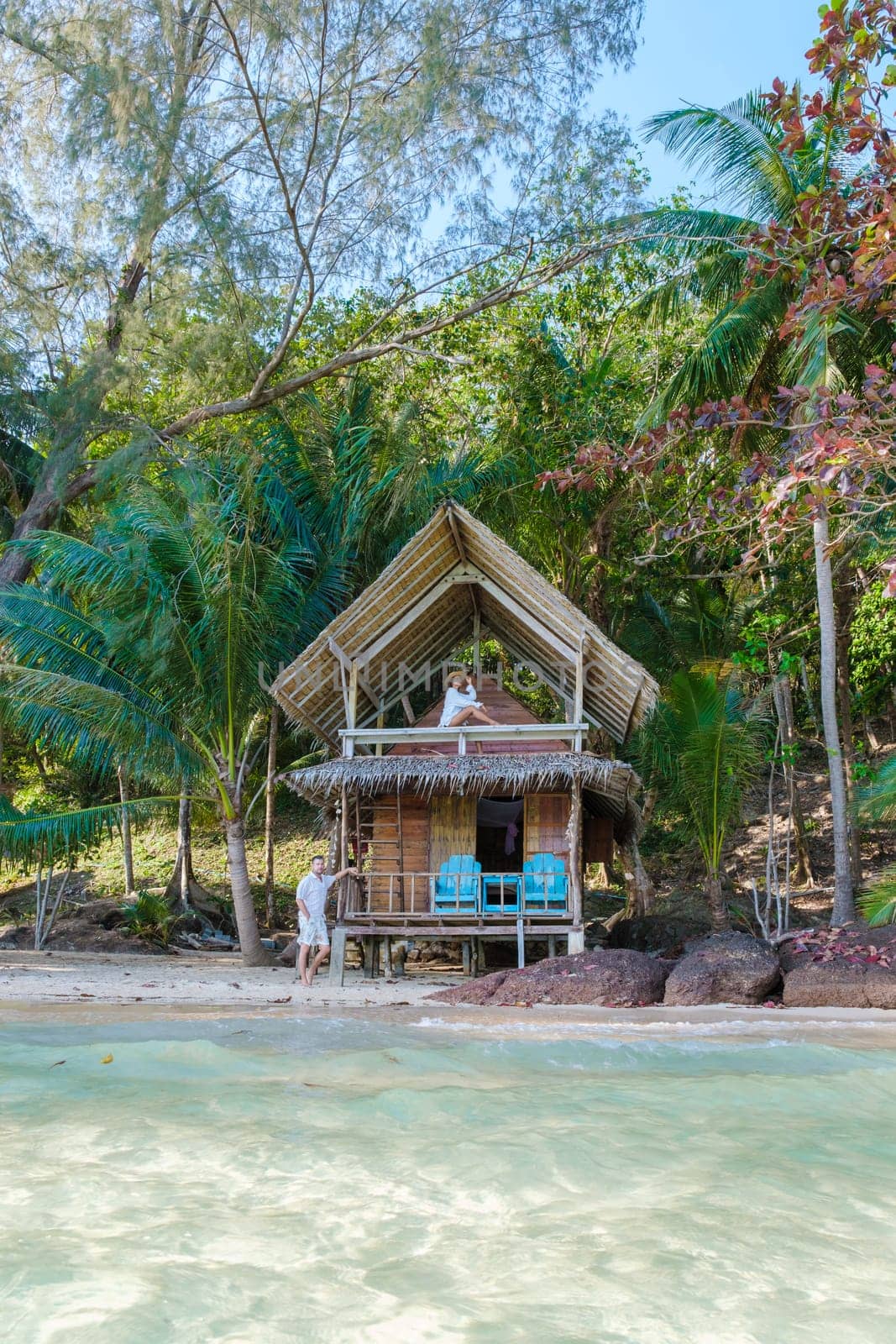 Koh Wai Island Trat Thailand is a tinny tropical Island near Koh Chang. wooden bamboo hut bungalow on the beach. a young couple of men and woman on a tropical Island in Thailand