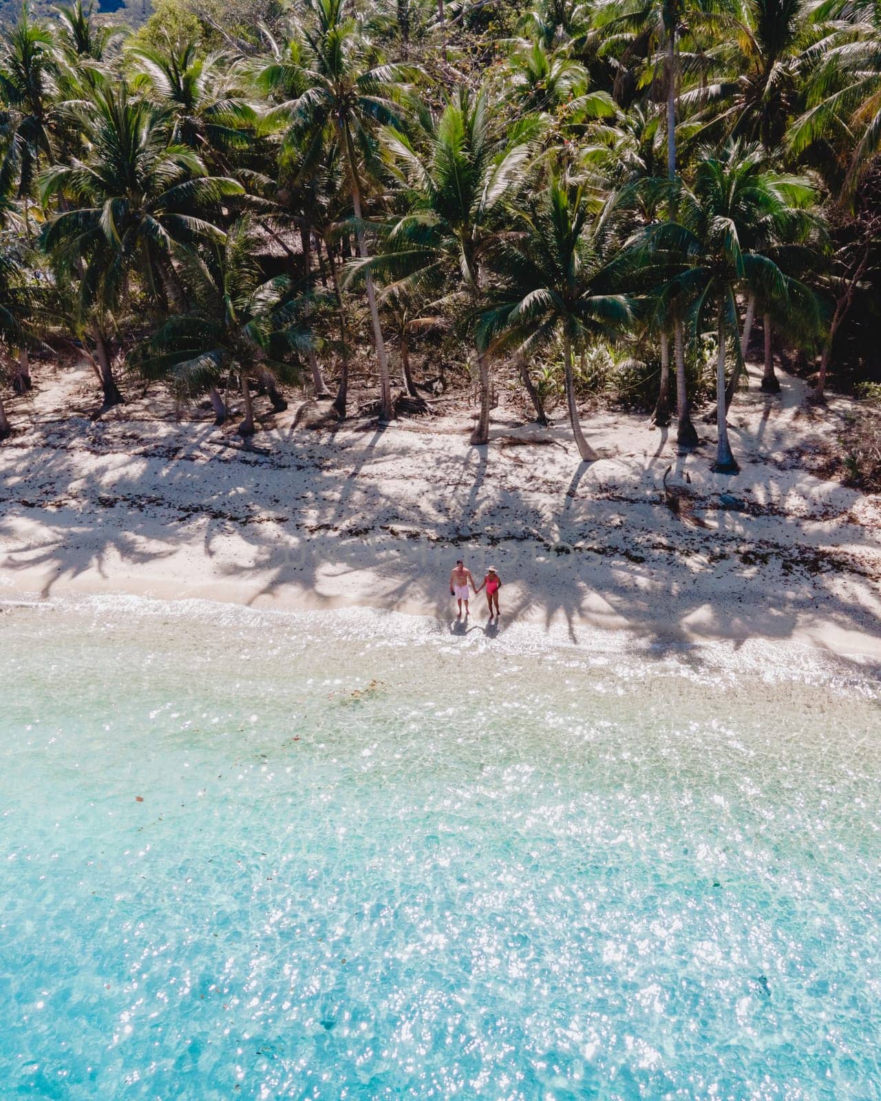Drone aerial view at Koh Wai Island Trat Thailand is a tinny tropical Island near Koh Chang. a young couple of men and women on a tropical beach during a vacation in Thailand