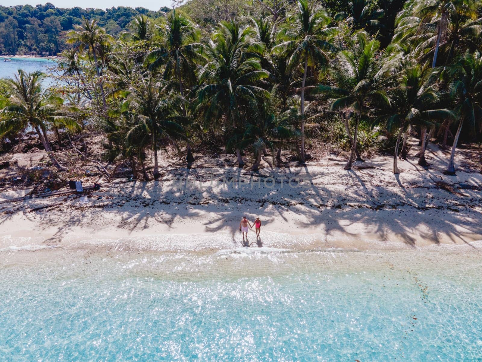 Drone aerial view at Koh Wai Island Trat Thailand is a tinny tropical Island near Koh Chang. a young couple of men and women on a tropical beach during a vacation in Thailand