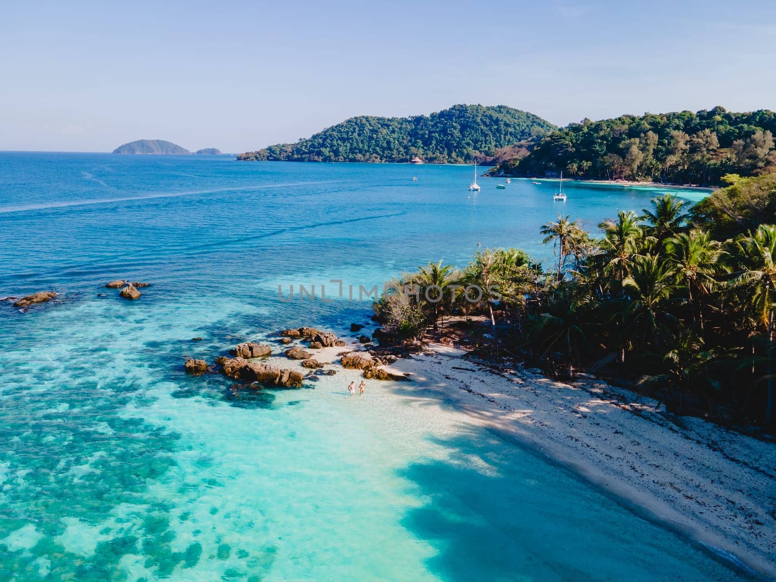 Drone aerial view at Koh Wai Island Trat Thailand is a tinny tropical Island near Koh Chang. a young couple of men and women on a tropical beach during a luxury vacation in Thailand