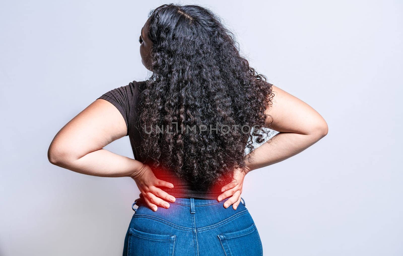 People with spine problems. Woman with back pain on isolated background. lumbar problems concept. A sore girl with back pain by isaiphoto