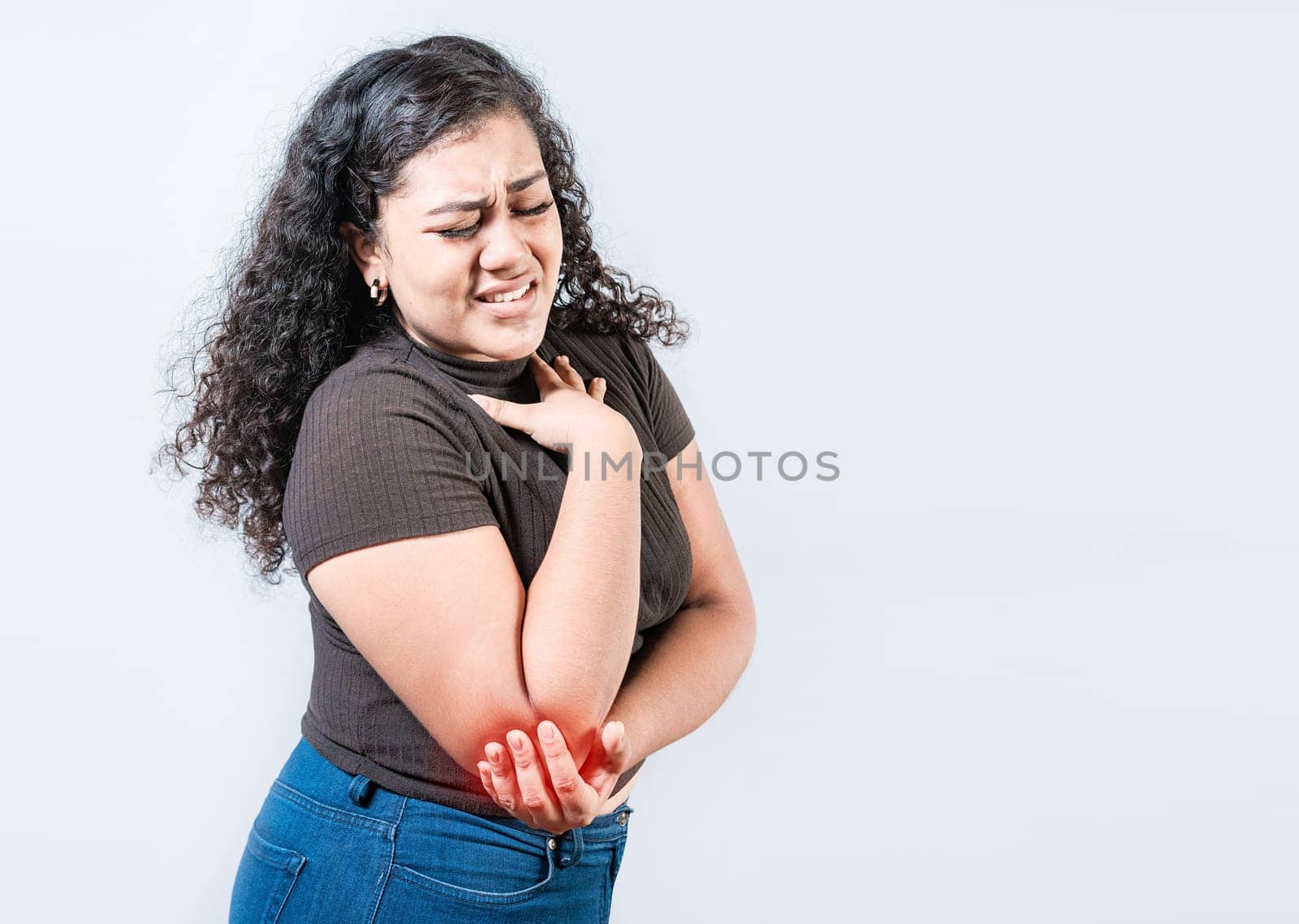 People with elbow pain isolated. Woman with elbow pain from rheumatism. Young girl suffering cramp elbow isolated by isaiphoto
